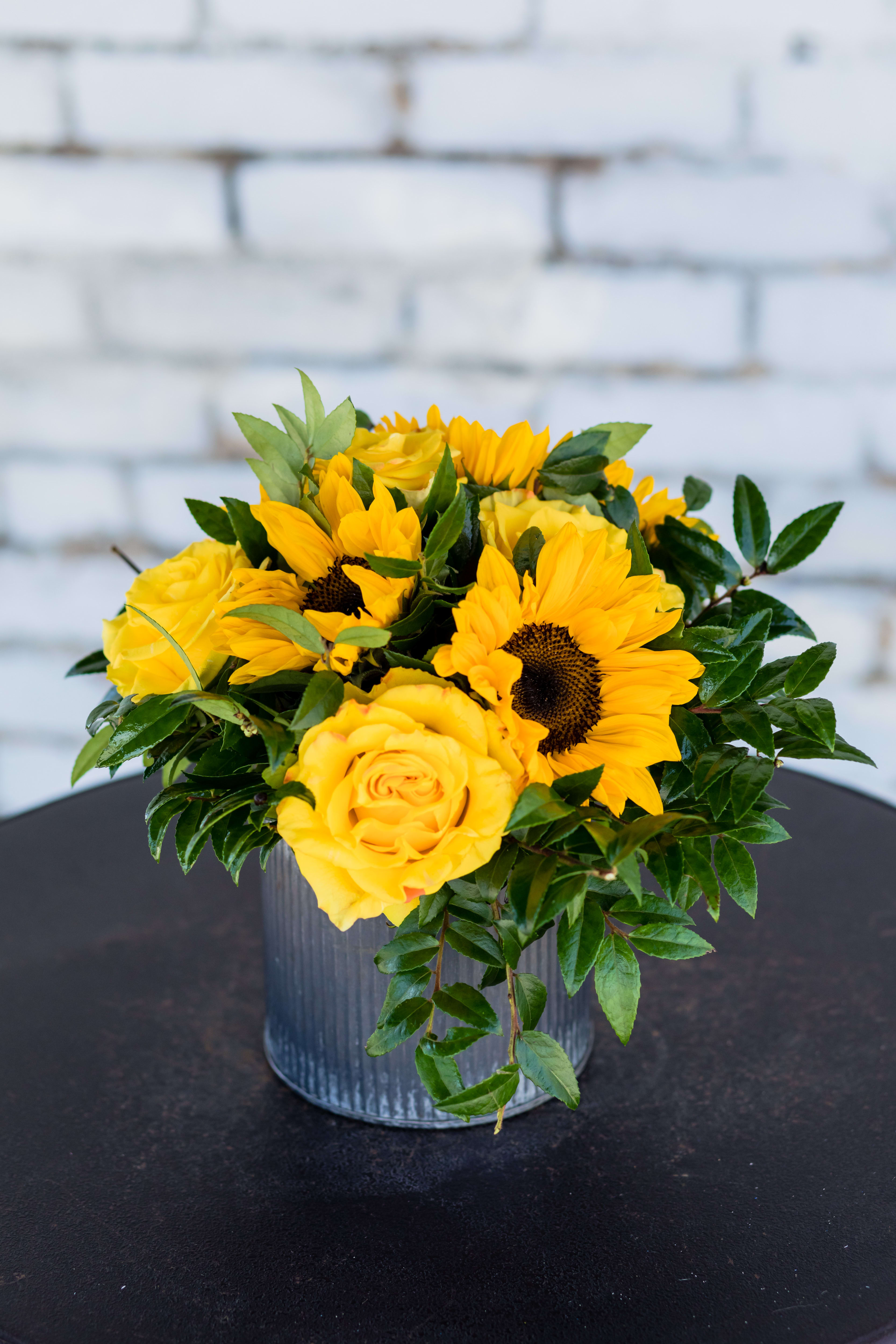 Country Sunflower - We take the sunniest sunflowers and roses around, put them in a designer corrugated tin vase  for that country chic look!