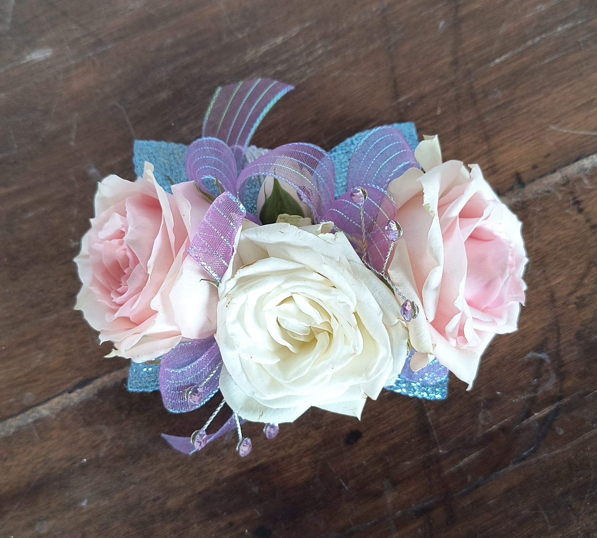 Pastel Shimmer Wrist Corsage - Do you have that dress that's blue but not blue, lavender but not lavender, pink but not pink. All depends on the angle and lighting. This is the best of all worlds. Accented with 2 rhinestone gem sprays. Disposable elastic wristlet included.