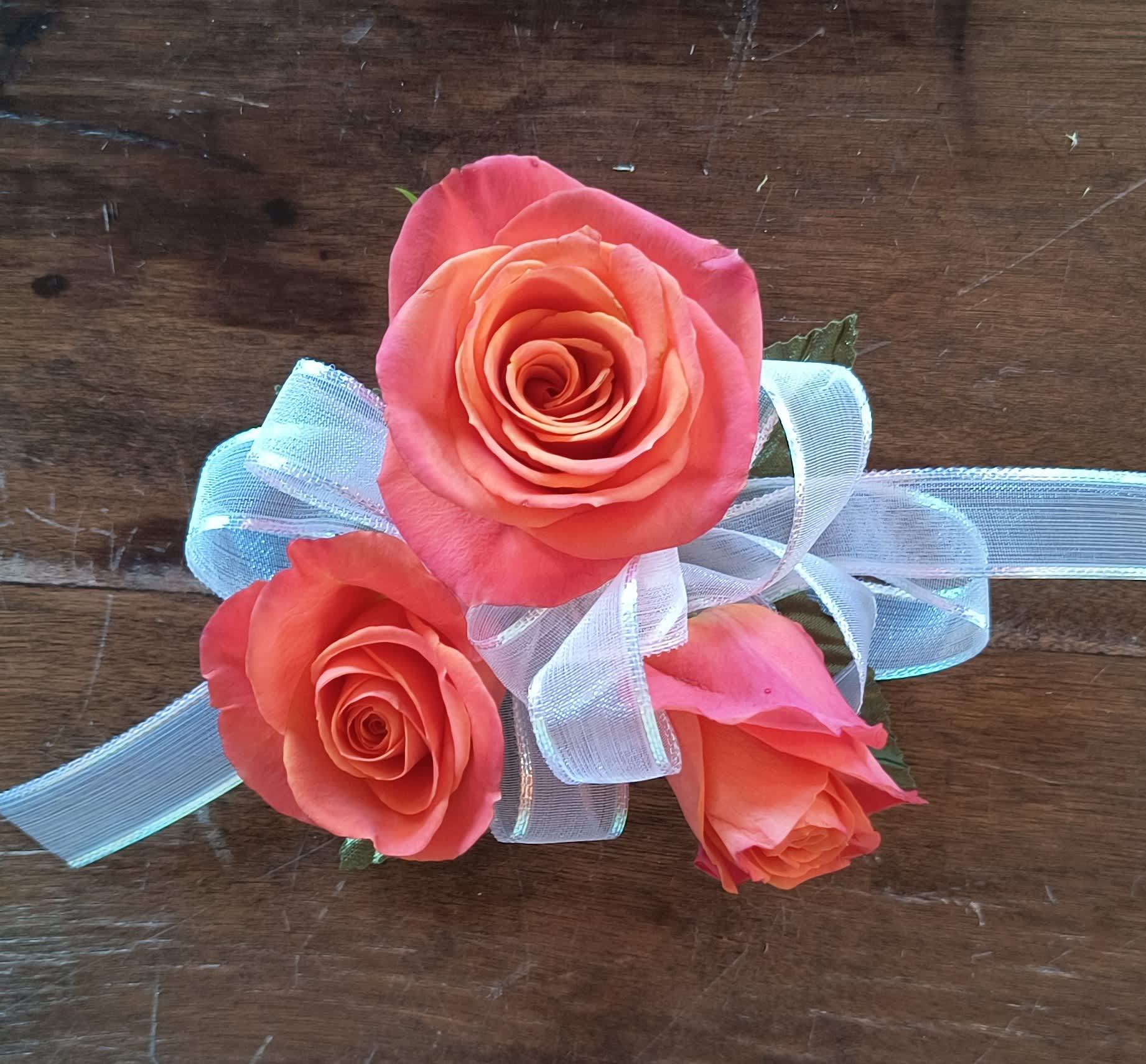 Orange Rose Wrist Corsage - A designers choice wrist corsage of orange spray roses, add as many accessories as you wish! *A disposable elastic wristlet is included.  *Shade of orange can vary.