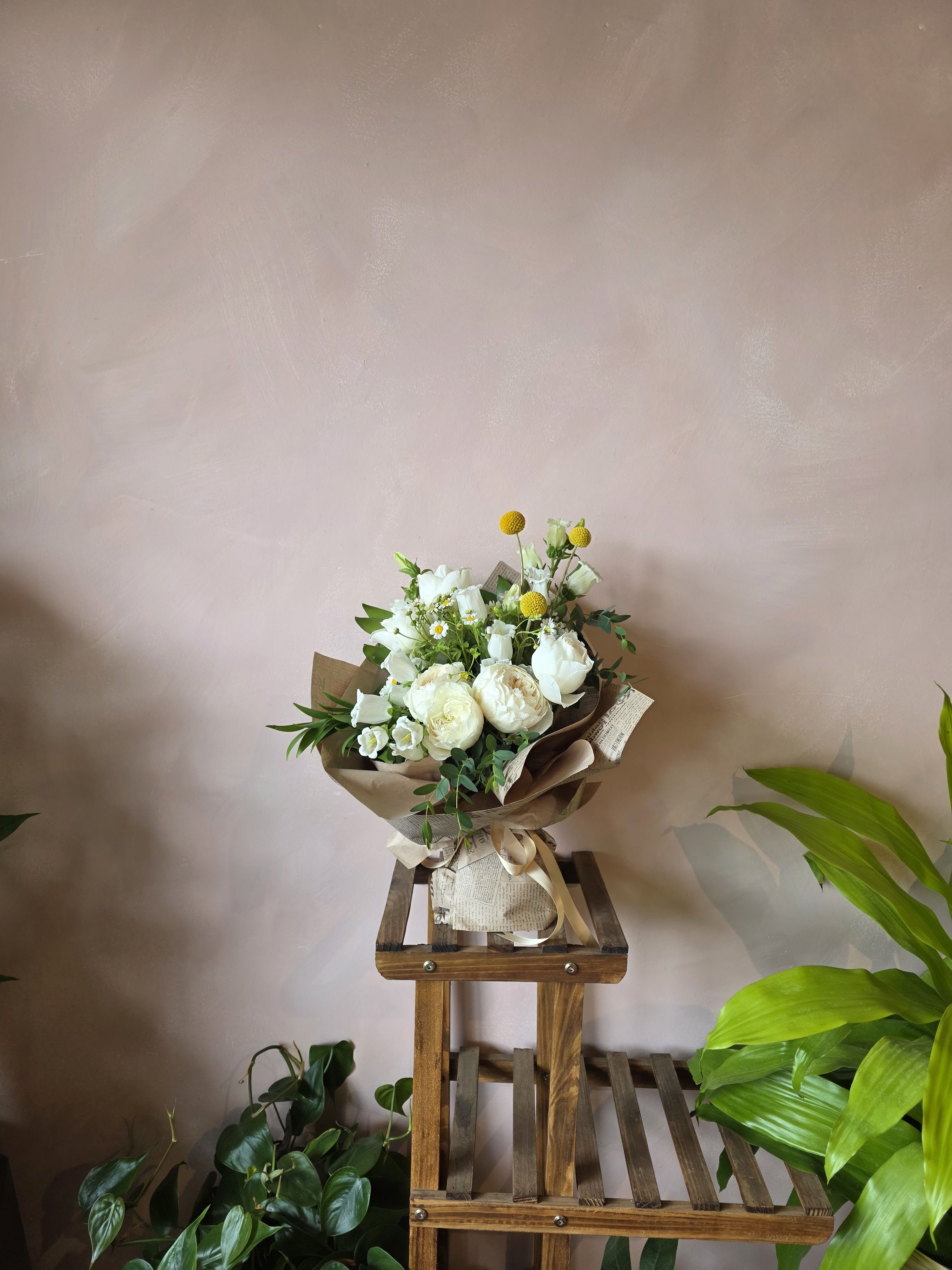 Sun-kissed  - A white mixed garden bouquet with the subtlest pops of yellow create this refreshing and artfully gift wrapped bouquet.