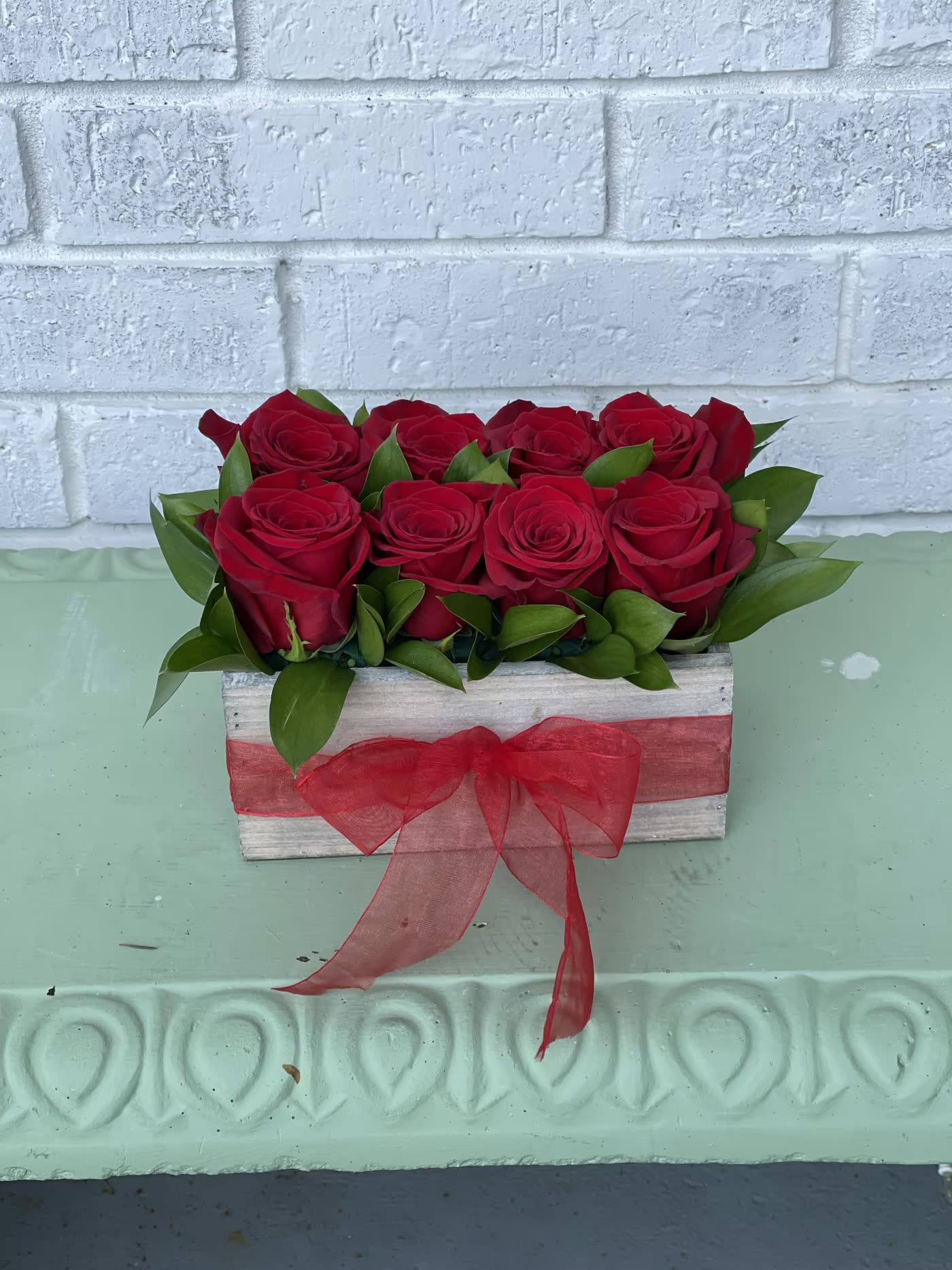 The romantic window box  - 8 beautiful roses in a wooden box paired with a pretty ribbon 