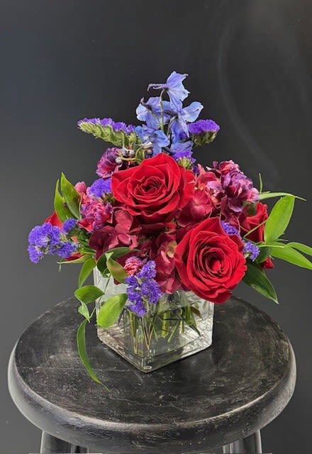 A Kiss of Love - Sending that special someone A Kiss of Love is the perfect way to clarify your feelings for them and let them know how important they are to you.  The rich, deep colors how the intensity of your love like nothing else can.  Normally made in a clear cylindrical vase, this arrangement is a show stopper, sure to win their heart!