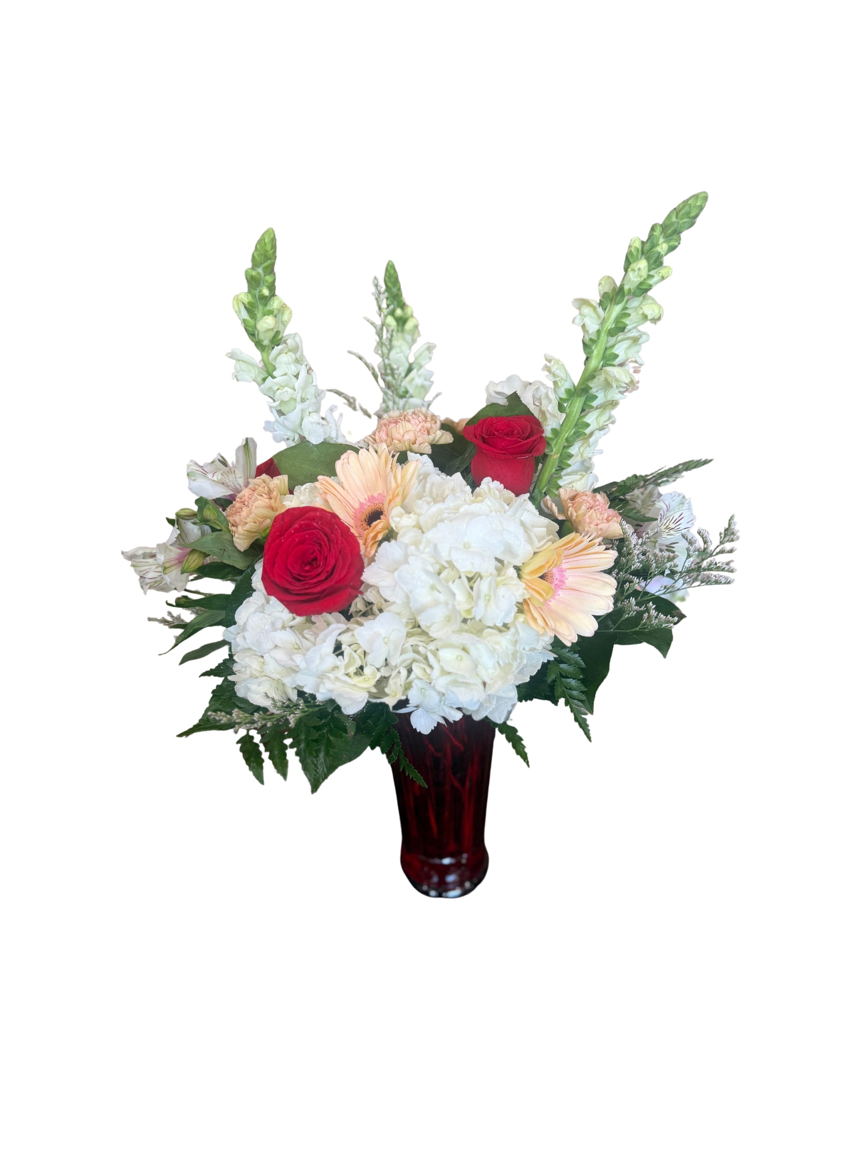 Graceful Love  - A timeless expression of love and elegance, this arrangement features rich red roses nestled among lush white hydrangea, soft blush gerbera daisies, and delicate accent blooms. Designed with graceful height and fullness, it’s artfully arranged in a deep red glass vase for a classic yet striking presentation. Perfect for anniversaries, romantic gestures, or anytime you want to make a heartfelt statement.