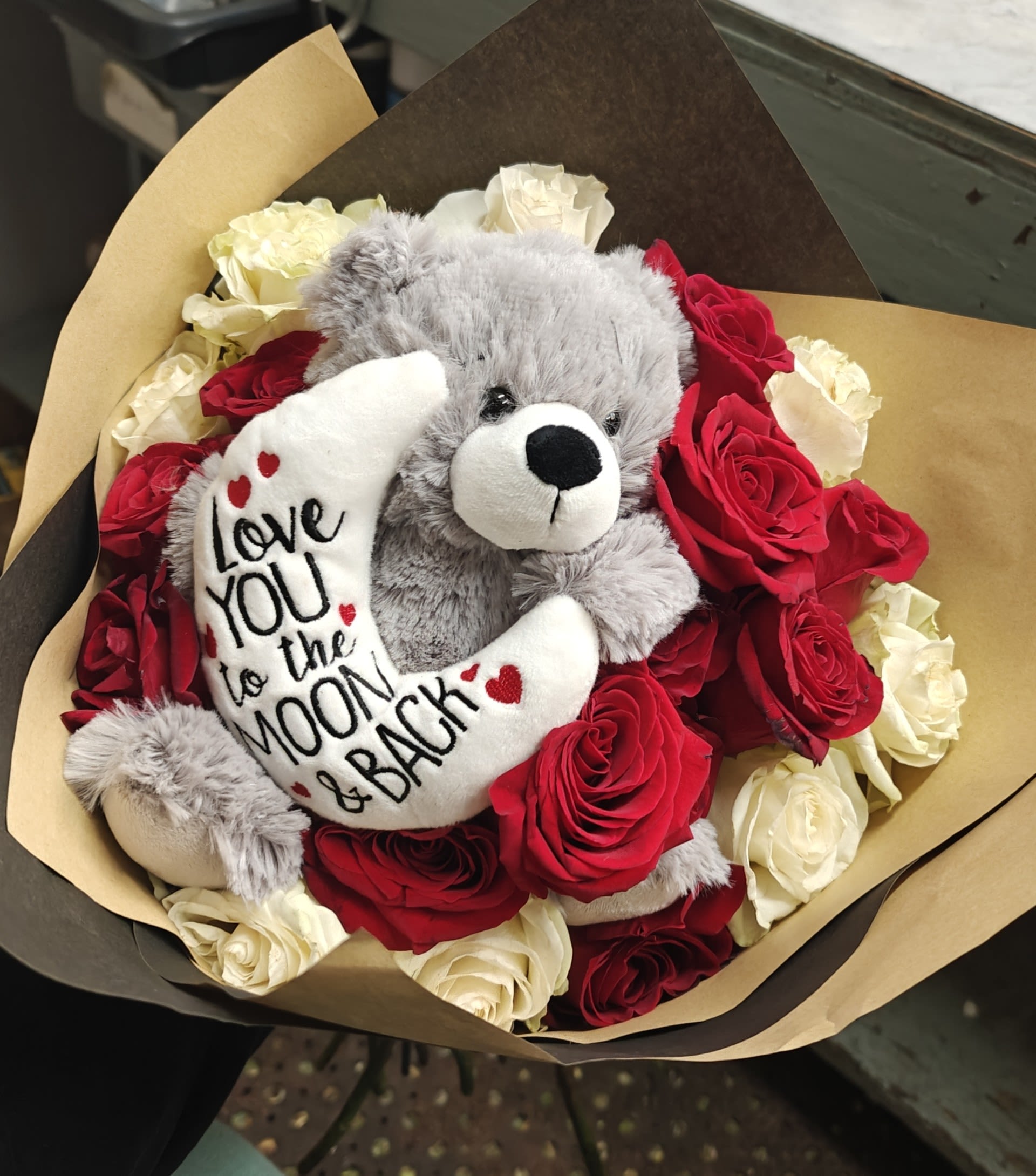 WRAPPED IN TEDDY'S LOVE - 2 DOZEN ROSES SURROUNDING A LOVING TEDDY BEAR IN A WRAP, WILL BE A SPECIAL VALENTINES DAY GIFT FOR THAT SPECIAL SOMEONE. PLEASE SPECIFY COLOR OF ROSE IN SPECIAL INSTURCTIONS.
