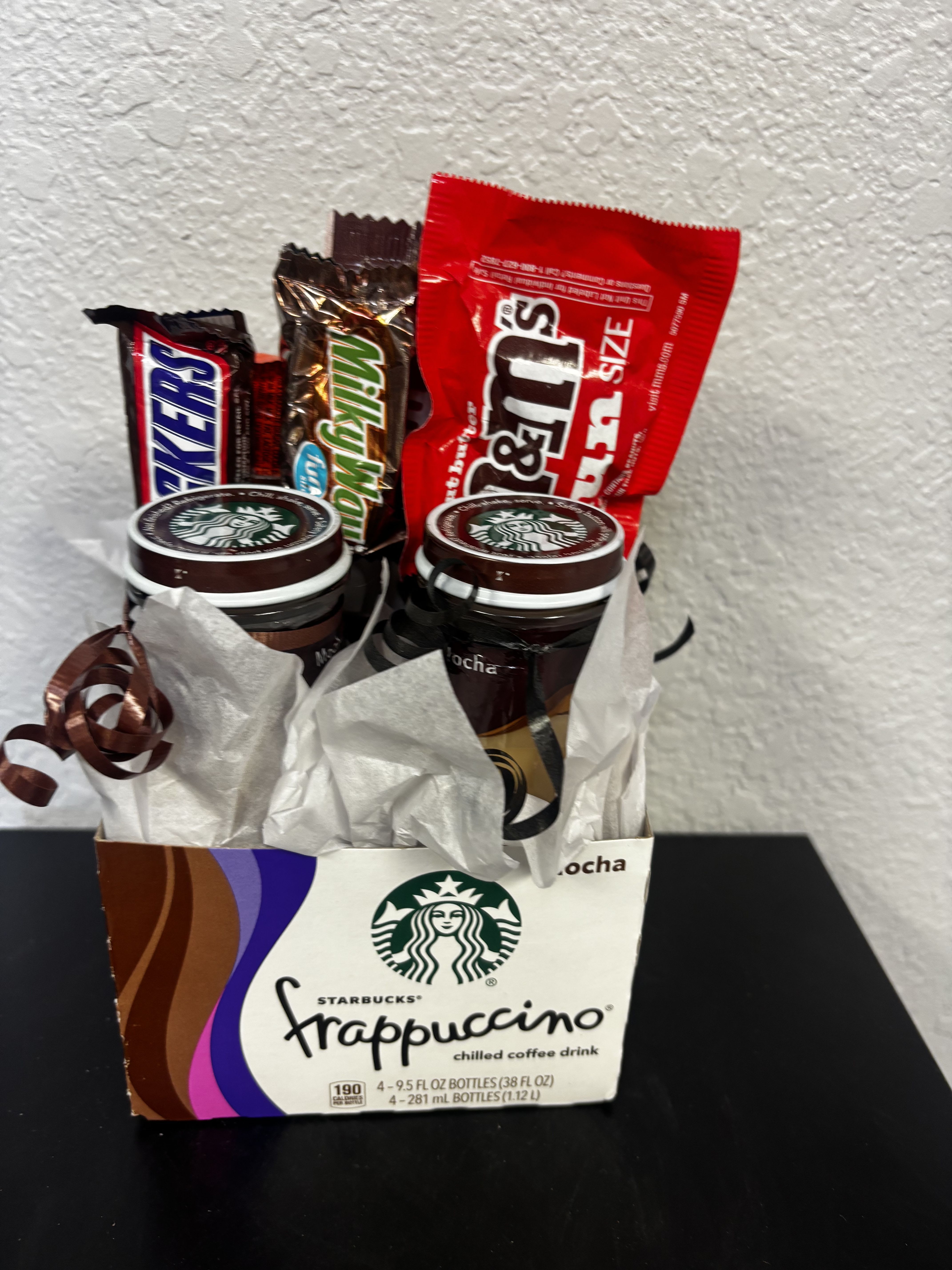 Starbucks Mocha Frappuccino/Candy Gift Set - Rich, chocolatey, and perfect for late-night cravings — this coffee and candy combo is a dream for mocha lovers. Built on a creative base using a Starbucks Frappuccino box, this gift features indulgent mocha dessert jars paired with classic chocolate favorites like Snickers, Milky Way, and M&amp;M’s.  A great choice for birthdays, thank-you gifts, care packages, or anyone who loves chocolate + coffee together.