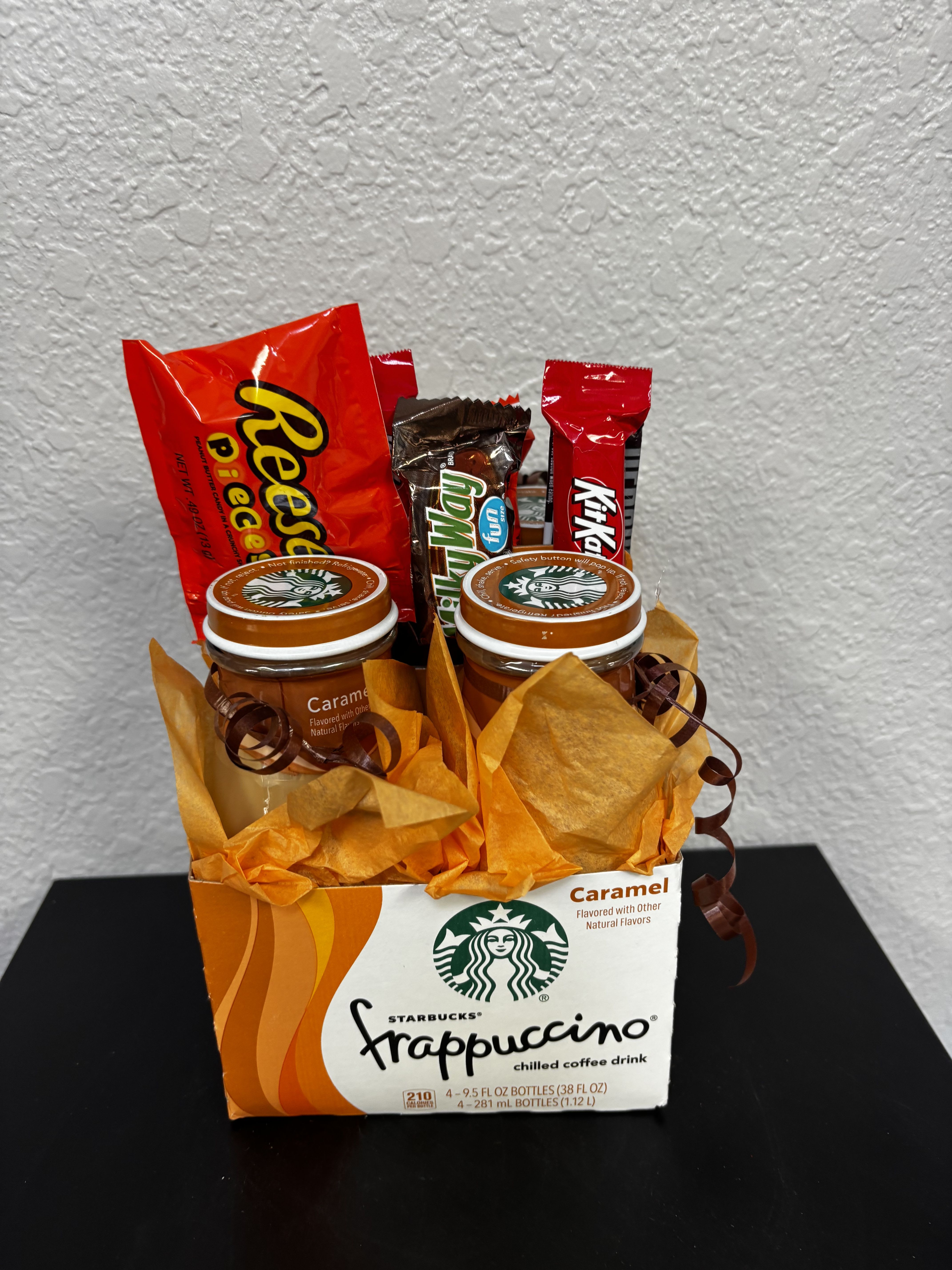 Starbucks Caramel Frappuccino/Candy Gift Set - The perfect pick-me-up for any sweet tooth and coffee lover! This fun and flavorful gift features a creative base made from a Starbucks Frappuccino box, filled with rich caramel dessert jars and a delicious assortment of chocolate favorites like Reese’s, KitKat, and Twix. Perfect for birthdays, thank-you gifts, thinking-of-you surprises, or just because — this gift delivers cozy coffee vibes with a sweet treat twist.