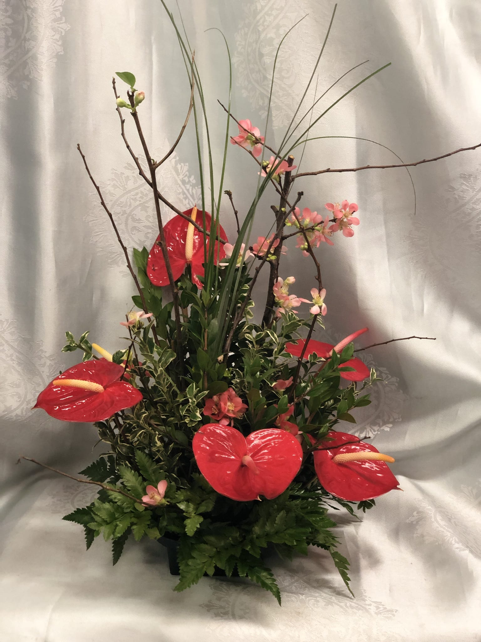 Anthurium winter blossom arrangement  - Passionate red Antherium meets elegant delicate winter blossom artfully designed. 