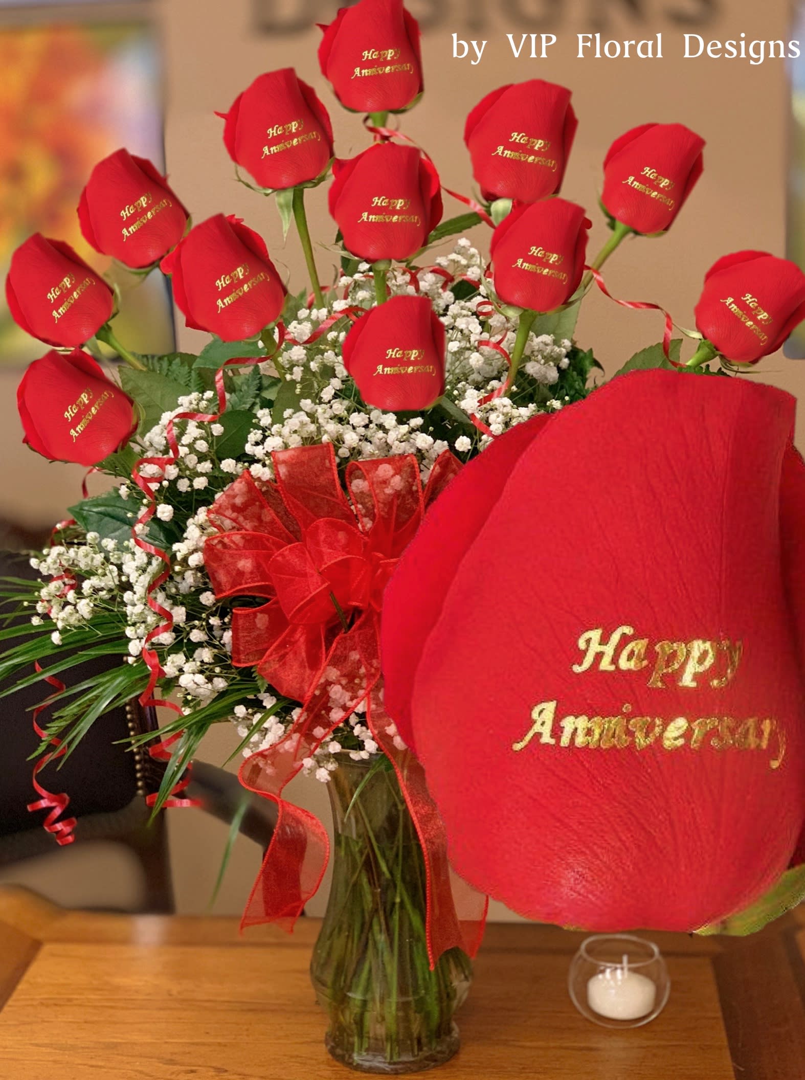  "Happy Anniversary" Personalized Roses - One dozen long stem roses each individually rose personalized with the message as shown, will arrive arranged in a glass vase, greens, filler, and bow. VIP Floral Designs uses only the highest quality roses.  