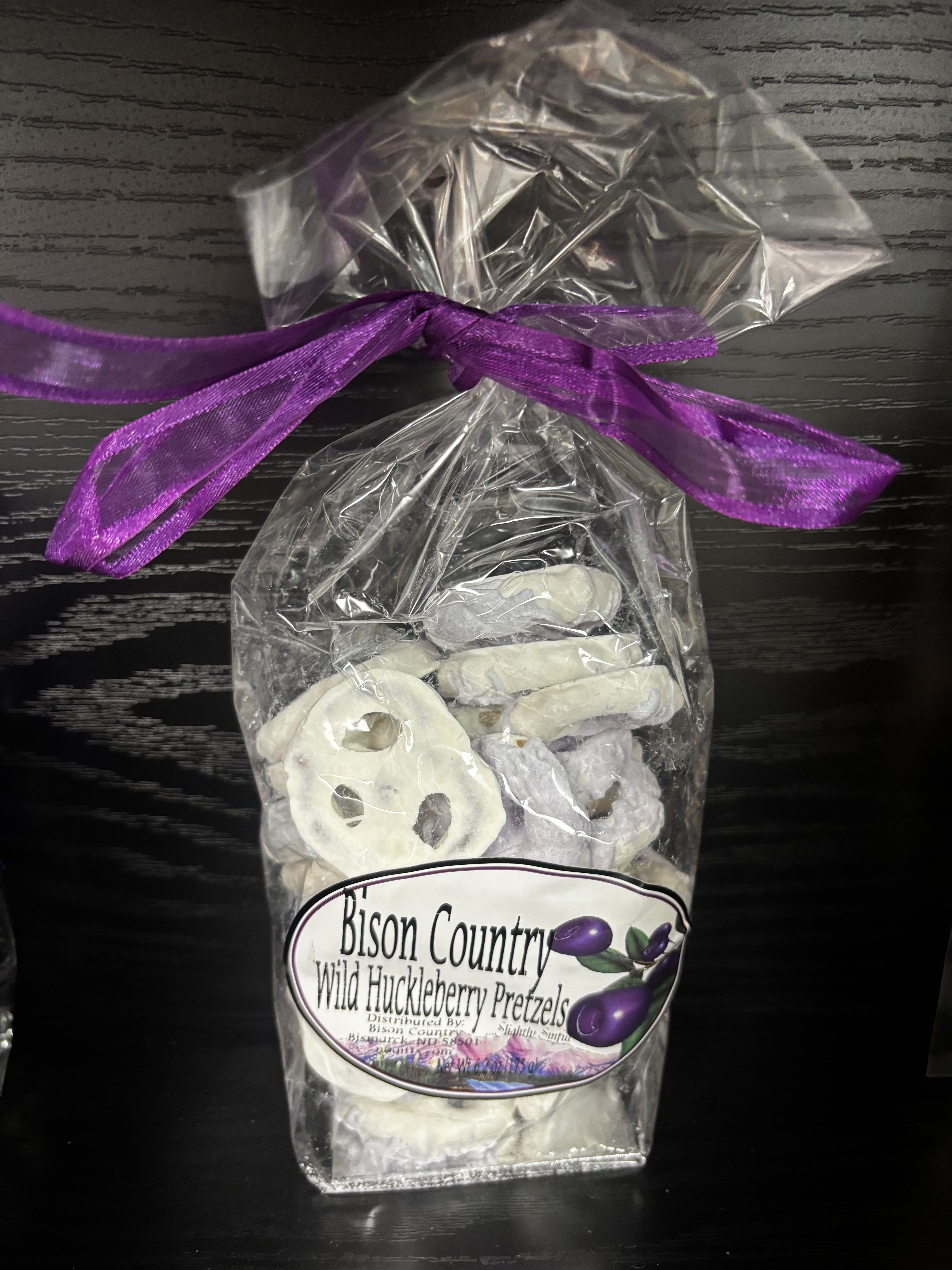 Bison Country Wild Huckleberry Pretzels - A sweet-and-salty Northwest favorite! Bison Country Wild Huckleberry Pretzels feature crunchy pretzels generously coated in a smooth, creamy huckleberry-flavored confection. The rich berry sweetness paired with the salty crunch creates an irresistible balance in every bite. Perfect for snacking, gifting, or adding a unique regional treat to gift baskets and displays. A standout choice for anyone who loves huckleberry flavor and a little indulgence with their crunch.