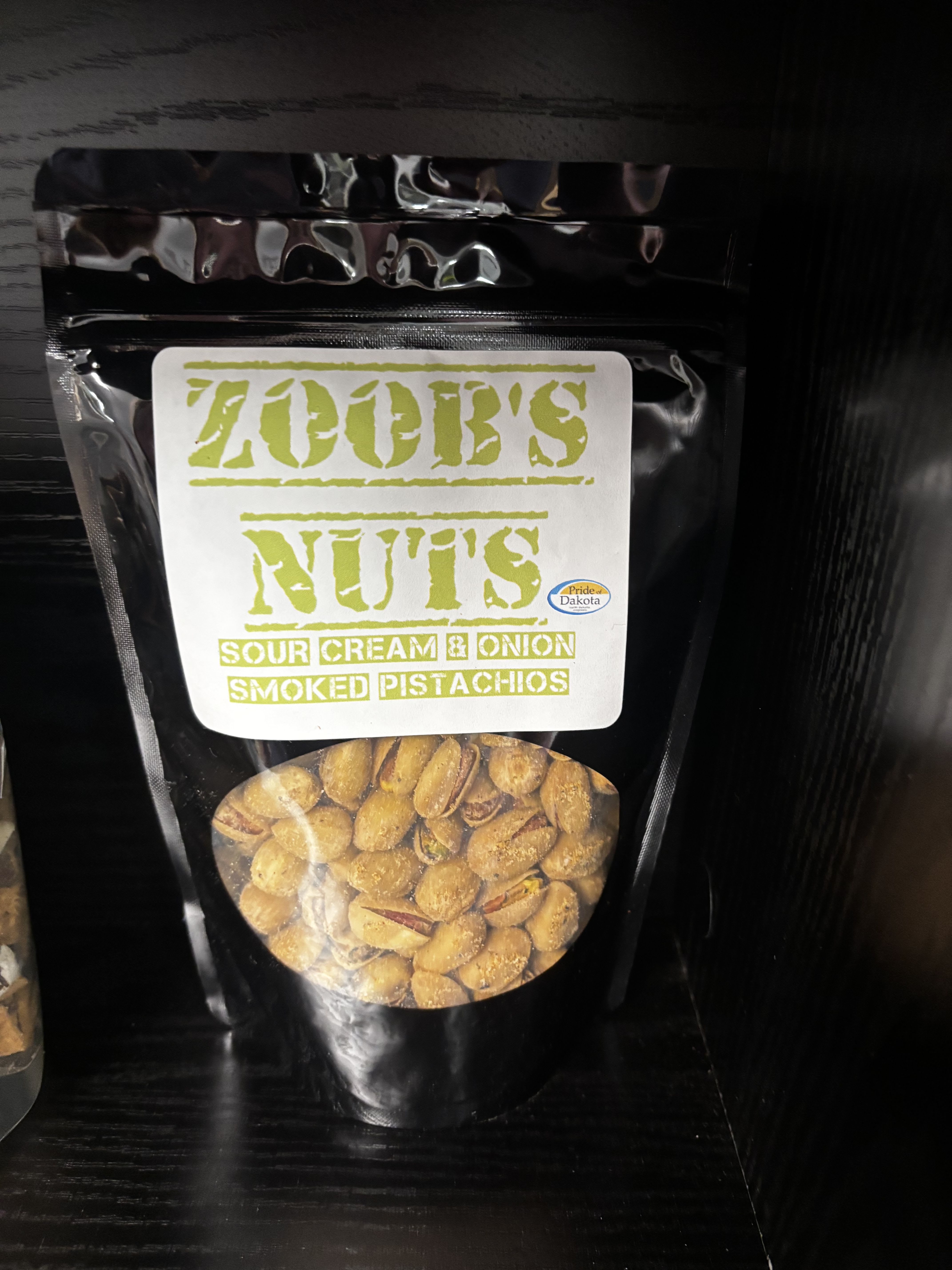 Zoob’s Nuts – Sour Cream &amp; Onion Smoked Pistachios - Crunchy, smoky, and full of bold flavor, these Sour Cream &amp; Onion Smoked Pistachios from Zoob’s Nuts are a snack-lover’s dream. Each pistachio is expertly smoked and seasoned with a creamy, tangy sour cream and onion blend that delivers just the right balance of savory and zest. Perfect for everyday snacking, game days, road trips, or pairing with drinks. A standout, made-in-North-Dakota treat you’ll keep coming back to.