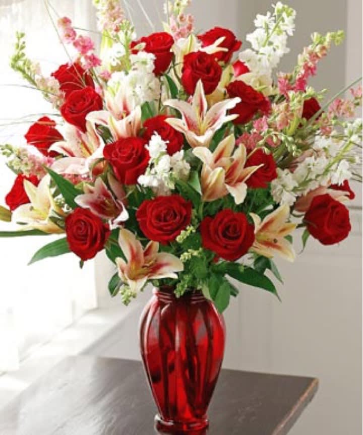 Valentine Splendor - Our breathtaking arrangement of fresh long-stem red roses, Stargazer lilies, larkspur and more is a gift of singular splendor!  Arrangement measures approximately 23”H x 22”D.