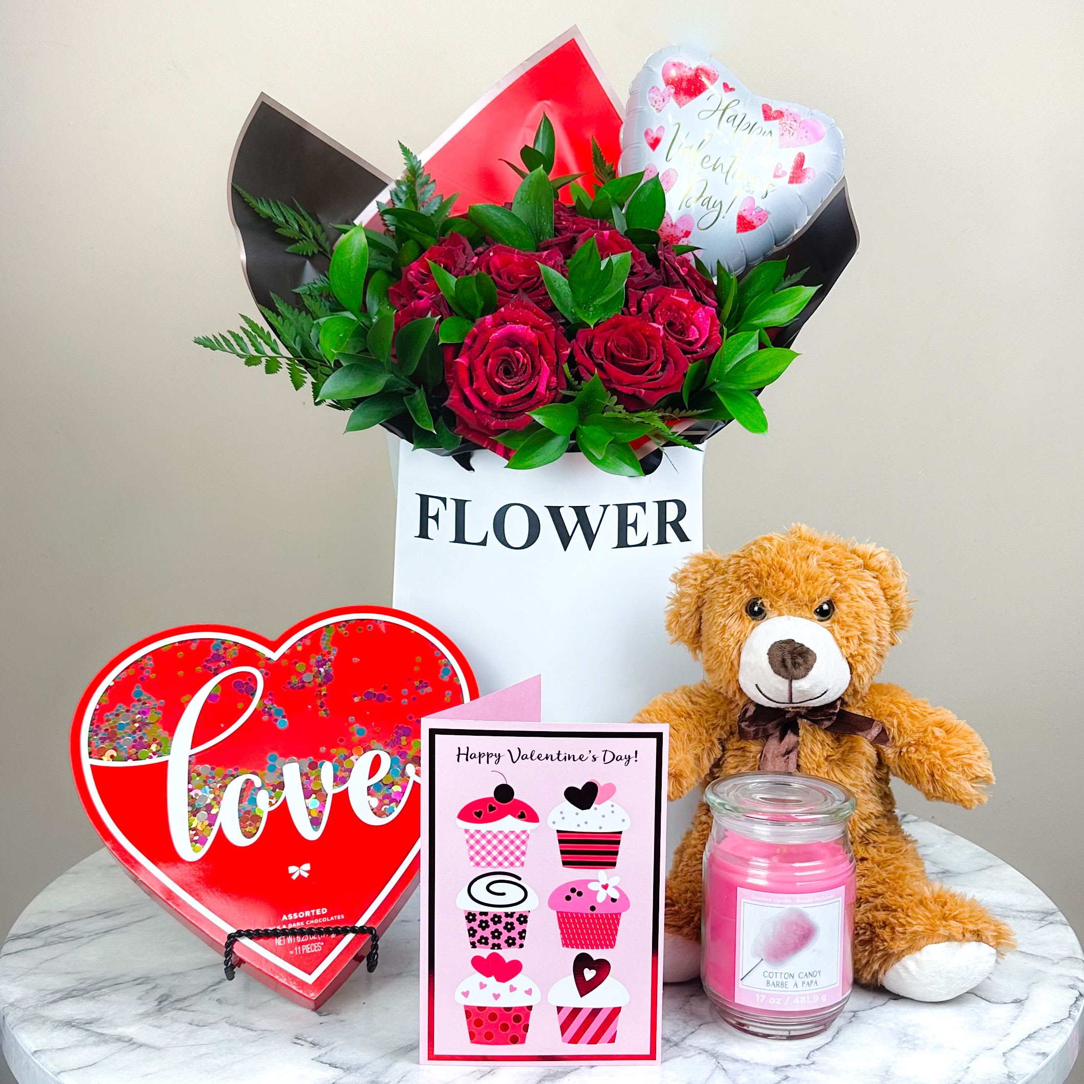 Valentine “Elite” Package - Bundle up this Valentine's Day and Save!  Specially curated for your loved ones’ sophisticated taste! This package includes a dozen extra long stem Ecuadorian red roses elegantly wrapped with fine greenery, an enchanting box of gourmet chocolate to satisfy the sweet tooth, scented candle for the romance, a cute and cuddly plush bear, heart shaped mylar balloon and a full size greeting card to send out the message of “Love” without saying a word…  Altogether comes with a keepsake and reusable “Flower” bag to carry out all your beautiful gifts in one!  *All color roses available! Please indicate your preference at "Special Instructions" upon checkout if different from pictured. 
