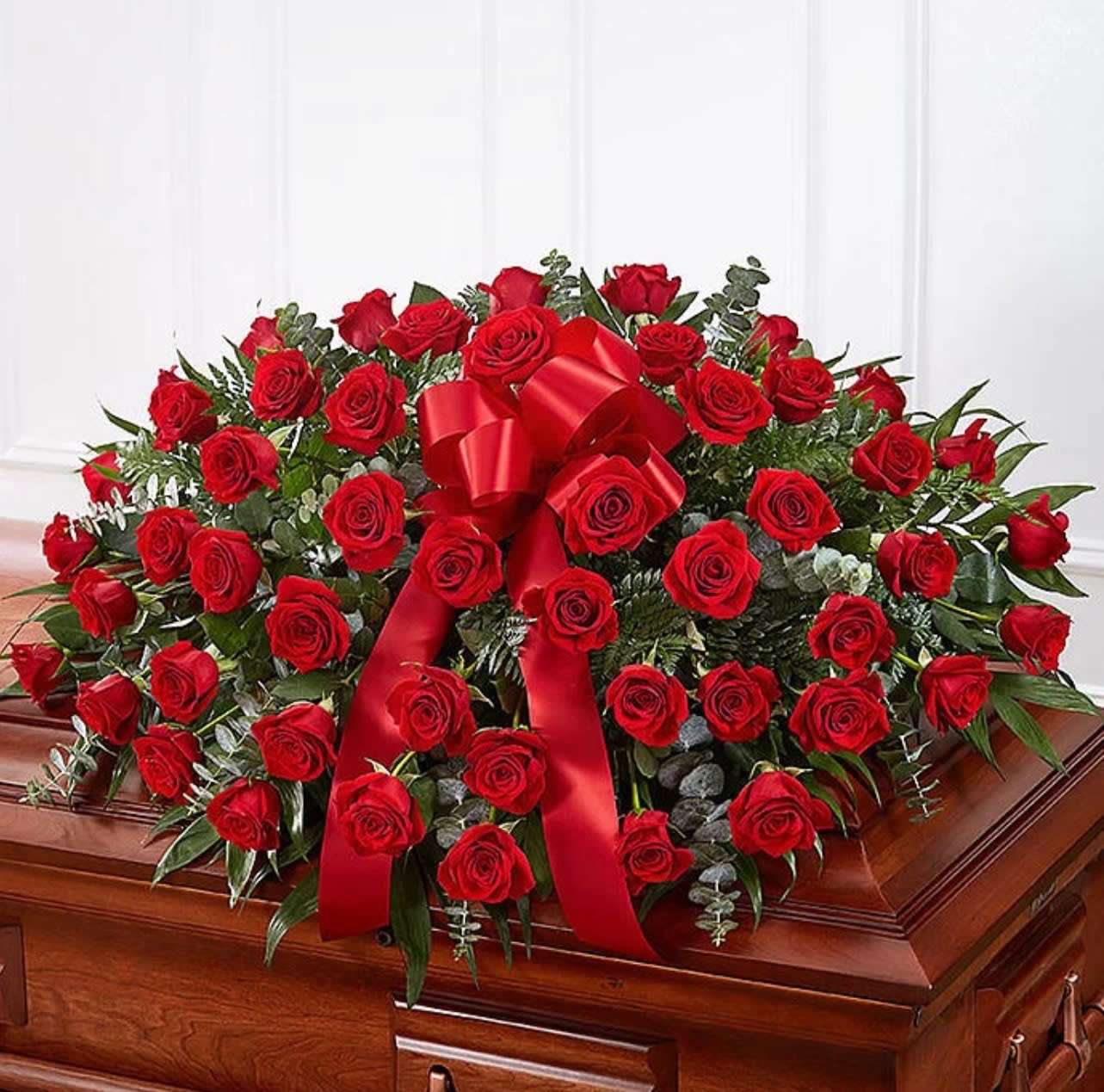 Red Roses Casket Spray  - A beautiful casket full of red roses and touches of baby blue eucalyptus. 