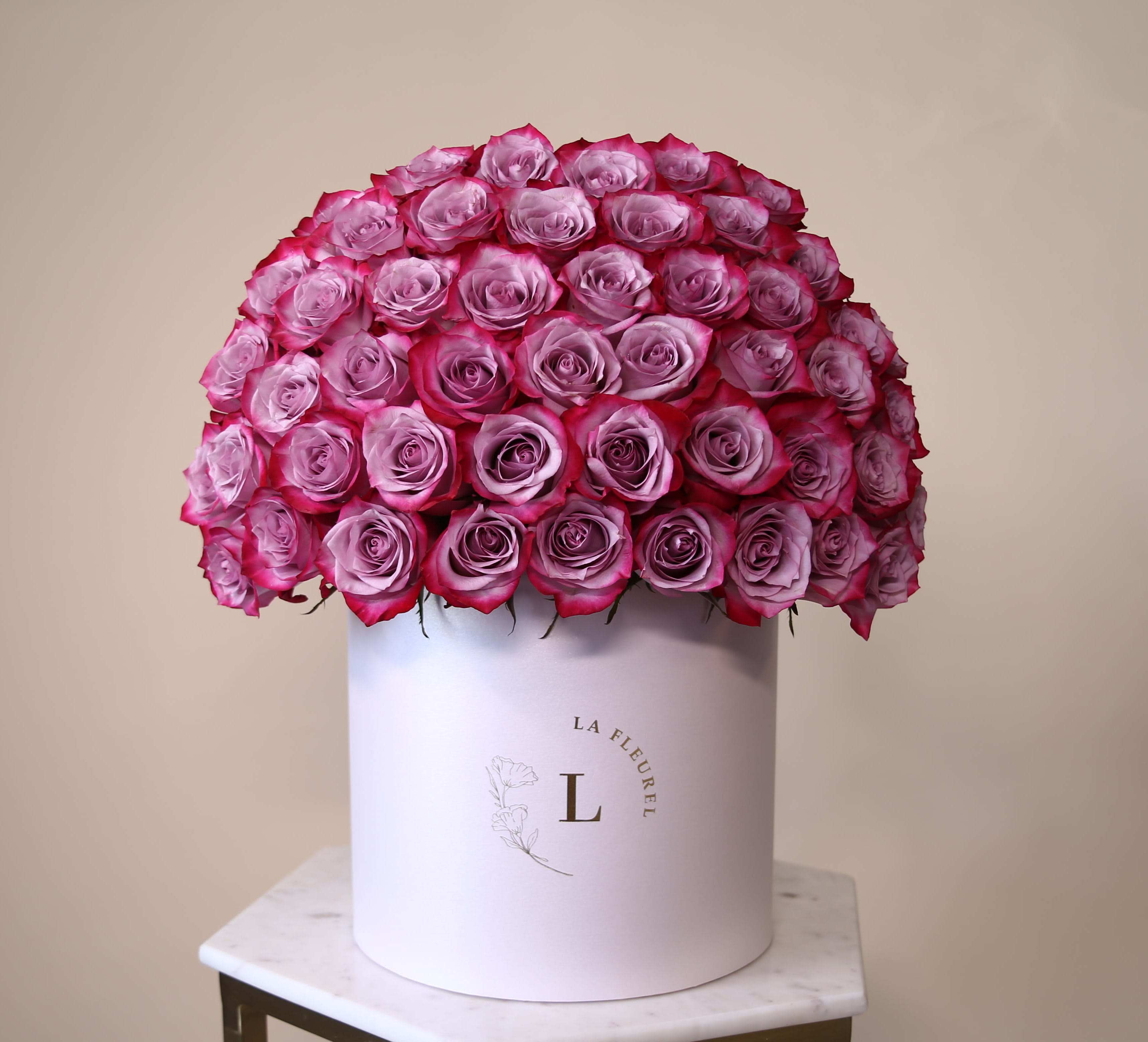 Deep Purple Roses - This beautiful box contains a combination of 45 to 50 fresh roses in a white box. This floral arrangment is the perfect gift for your loved one!   Large Size - 100 Roses   Arrangement includes: Fresh deep purple roses Medium box measured at 9.75" Dia. x 9.25" H Custom greeting card