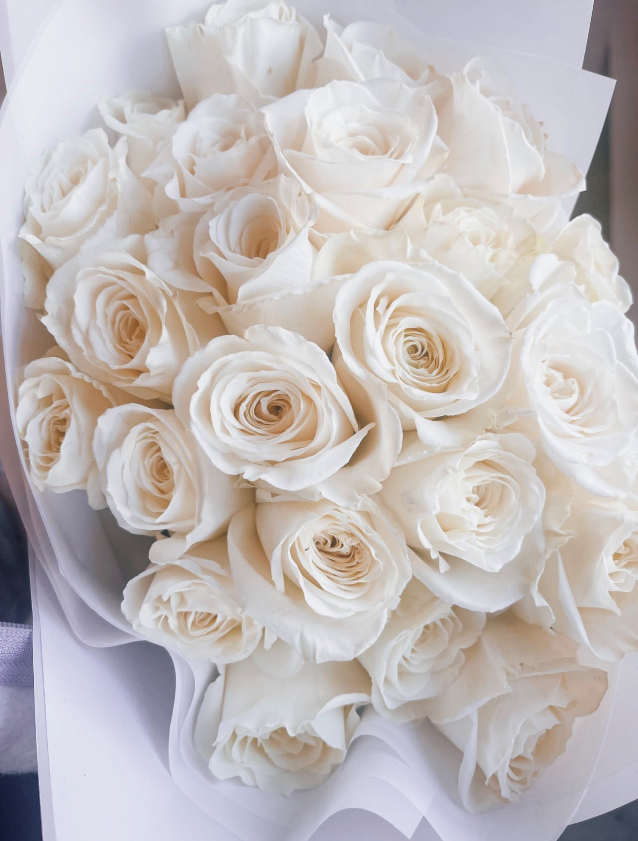 Sparks Fly -  Simple, elegant, and stunning white premium long stem hand-tied floral arrangement.   Standard: One dozen white roses  Deluxe: Two dozen white roses 