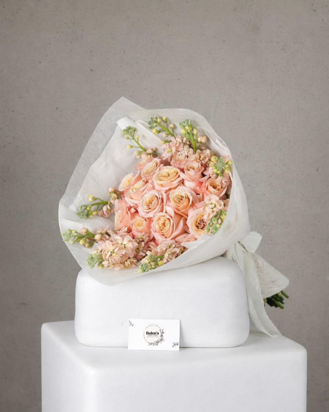 Ethernal Petals - Our Blush Romance Luxury Rose Bouquet is a timeless expression of elegance and love. Designed with premium blush and peach roses accented by delicate seasonal blooms and wrapped in soft white and beige paper, this arrangement is perfect for anniversaries, Valentine's Day, birthdays, and romantic celebrations.   Handcrafted by Balen's Floral Studio, a luxury florist in Orange County, California, this bouquet features fresh, high-quality flowers sourced daily for long-lasting beauty, Its modern yet romantic style makes it ideal for gifting or as a statement floral piece for special occasions.  Available for local flower delivery in Orange County, including Lake Forest, Irvine, Mission Viejo, and surrounding areas. Order this luxury rose bouquet today to send a message of love and sophistication.