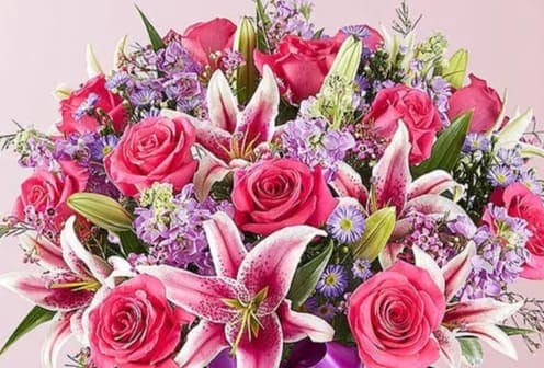 Hearts a Spring - A Spring assortment of  oriental Lilies,  Roses and assorted florals arrive in a vase masterly designed  just to make someone smile.