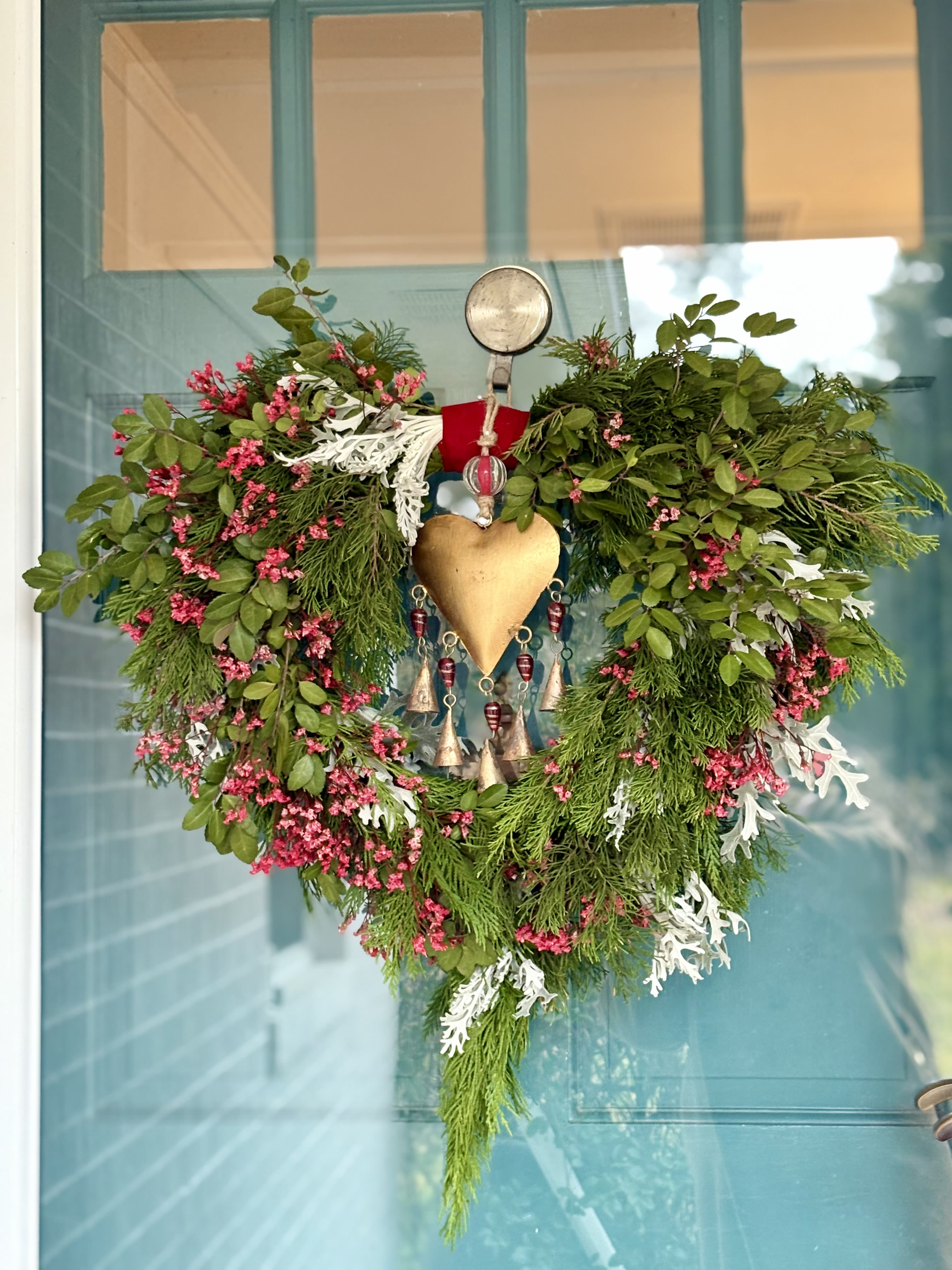 Love Bells - Evergreen Wreath with touches of red florals adorned with heart bell