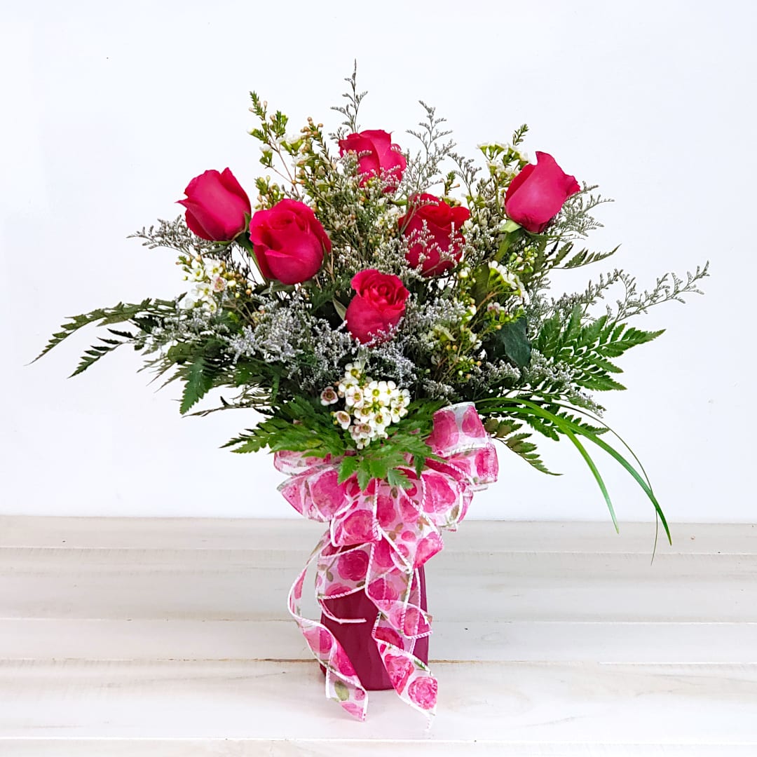 Romantic Delight - Take home the romance with a 6 rose bouquet that's just the right size... not too small and not too large. Artistically arranged for flash and appeal. She will love it!