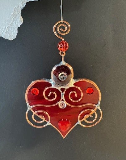 A Bit of My Heart Keepsake (red) - These beautiful hearts say it all!!! They are made out of stained glass and come in several different colors and tones of pink and red.  They can be hung by a suction cup (not included) or by a piece of thread from lamps, mirrors, windows, etc.  Can be used as an add-on to any of our floral arrangements of shipped as a separate item.  These hearts are available as wholesale items by reaching out to us at 540-810-2161.