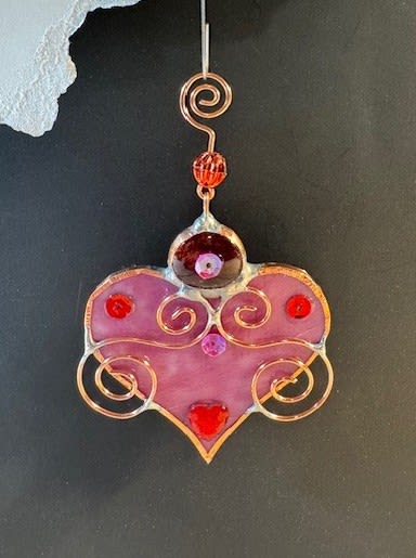 A Bit of My Heart Keepsake - These beautiful hearts say it all!!! They are made out of stained glass and come in several different colors and tones of pink and red.  They can be hung by a suction cup (not included) or by a piece of thread from lamps, mirrors, windows, etc.  Can be used as an add-on to any of our floral arrangements of shipped as a separate item.  These hearts are available as wholesale items by reaching out to us at 540-810-2161.