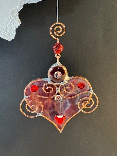 A Bit of My Heart Keepsake (red mottled) - These beautiful hearts say it all!!! They are made out of stained glass and come in several different colors and tones of pink and red.  They can be hung by a suction cup (not included) or by a piece of thread from lamps, mirrors, windows, etc.  Can be used as an add-on to any of our floral arrangements of shipped as a separate item.  These hearts are available as wholesale items by reaching out to us at 540-810-2161.