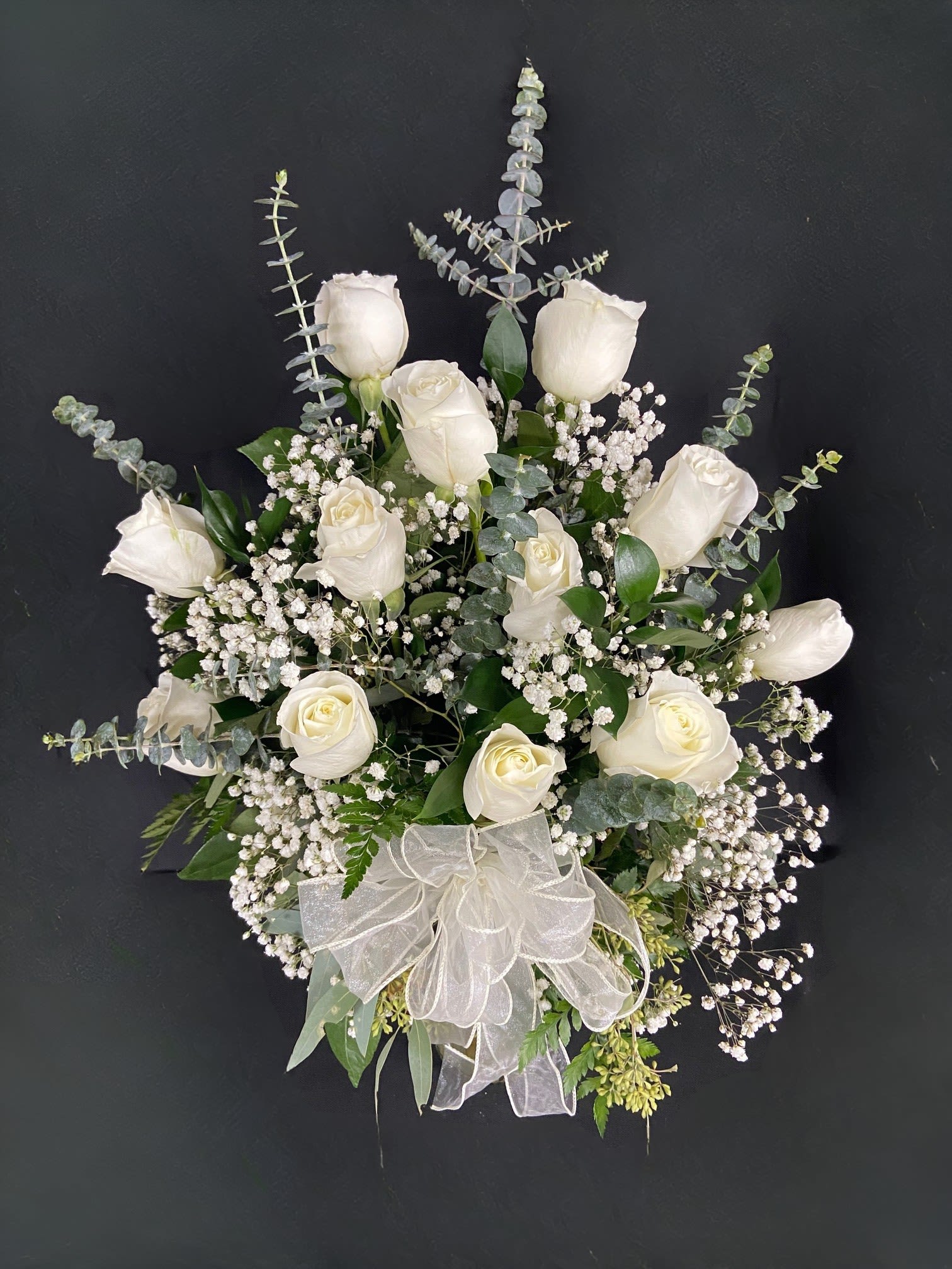 Classic White Roses - A dozen white roses are a classic gift! Perfect for Valentine's Day, an Anniversary, or any type of celebration. Standard (12 Roses), Deluxe (24 Roses), or Premium (36 Roses)