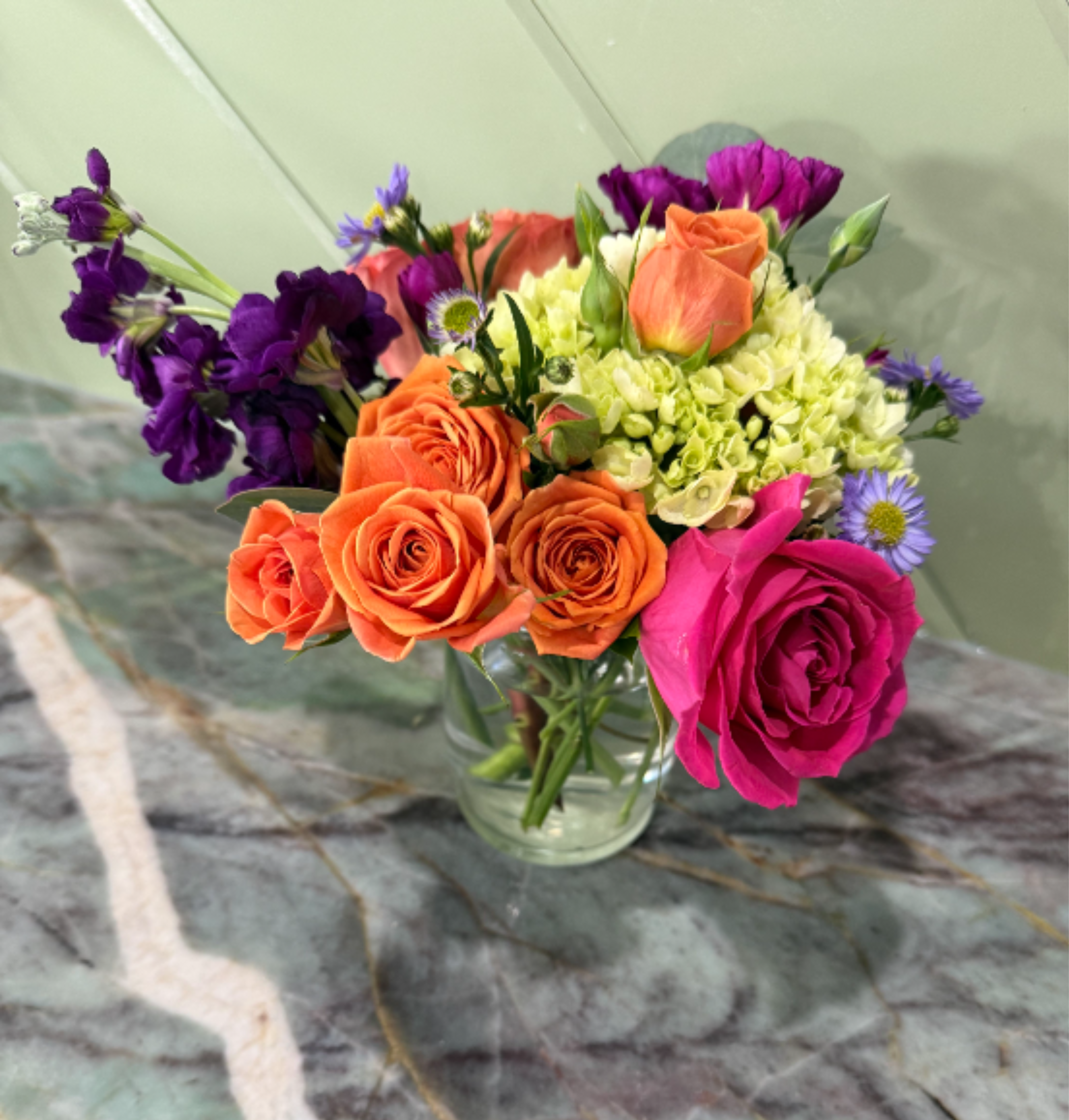 Bright little Beauty - A smaller arrangement but packed with beautiful bright blooms. Hydrangea, stock, mini roses and one pink rose