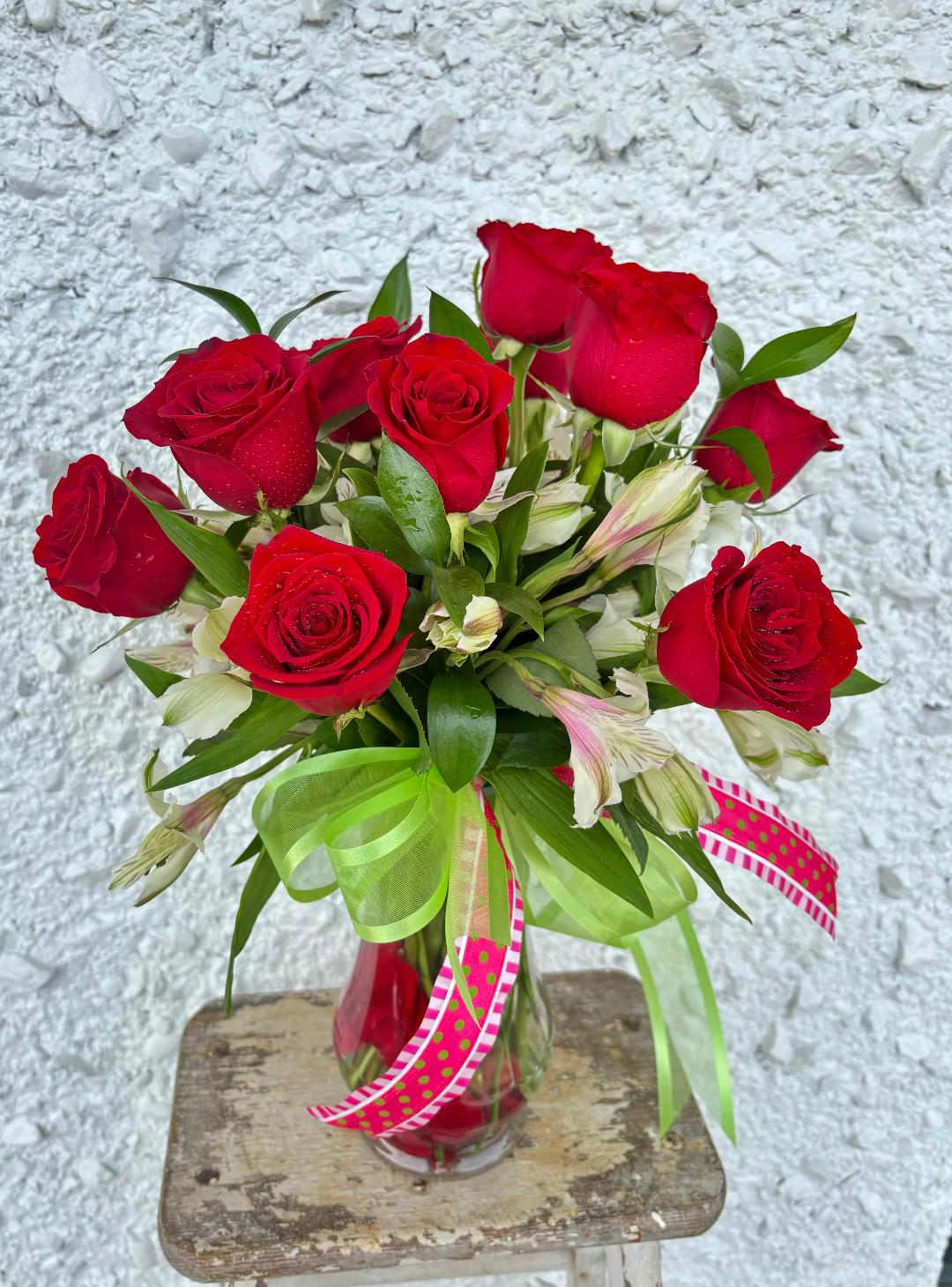 One Dozen Basic - This beatuiful display of roses with greenery and filler is sure to make someone very happy! If you would like to select a specific color of rose, please add it in the notes section along with a second preferance incase we are already sold of of that color.