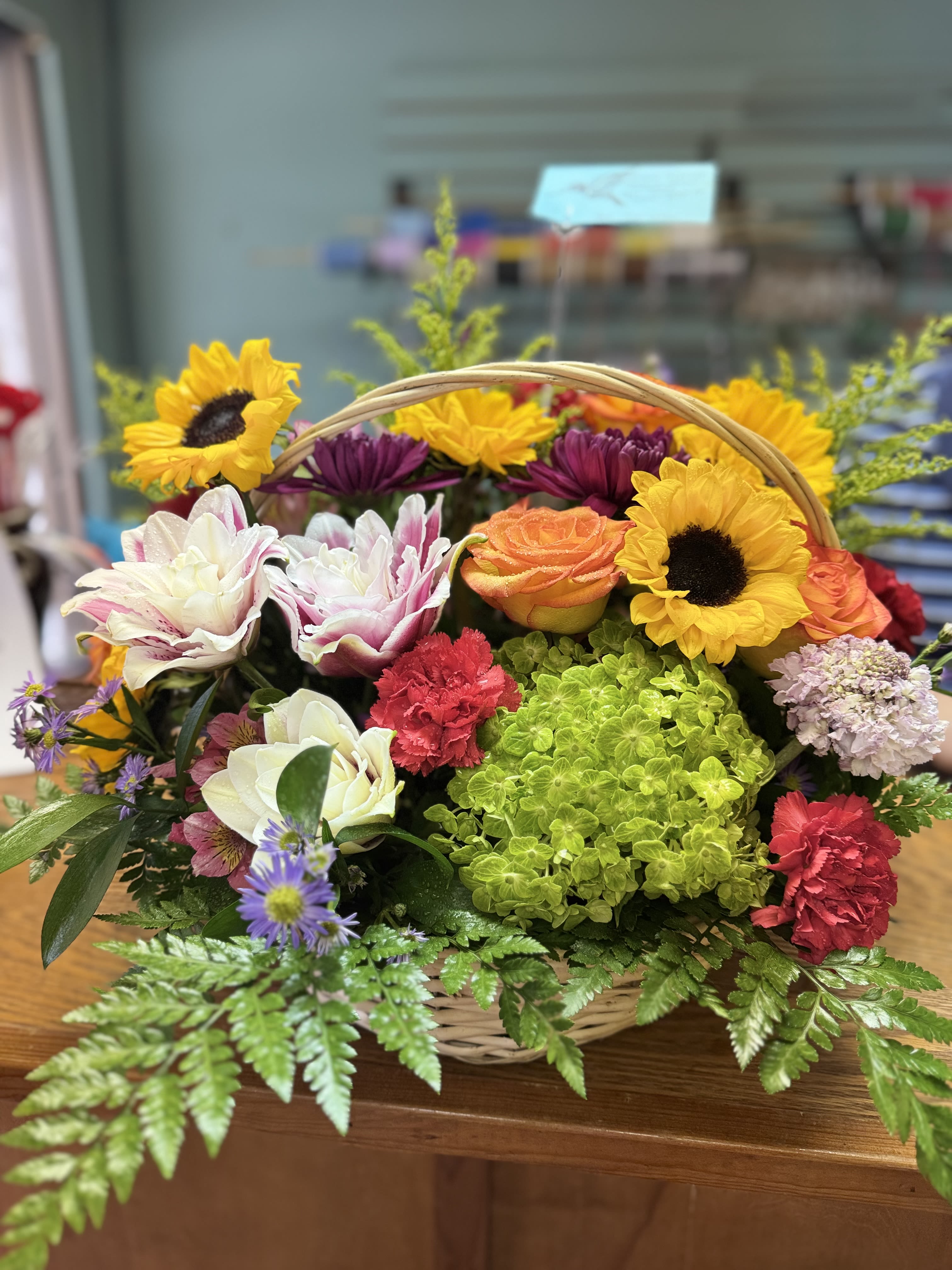 Summer Picking - This wonderful assortment of Summer Bloomers are sure to brighten someone's day. We use the freshest flowers in season for this beauty and present it all in a wicker basket.
