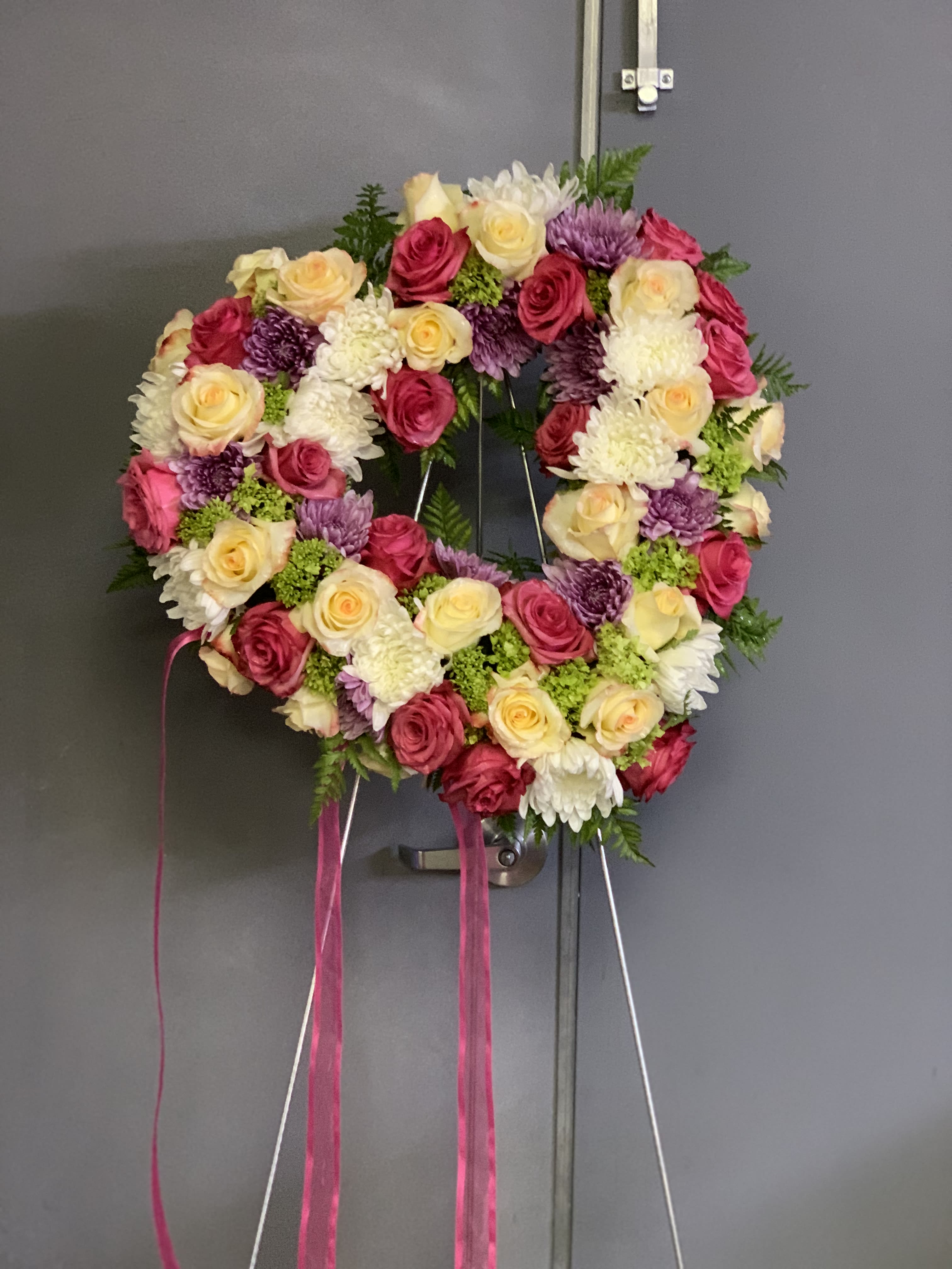 Cherished Heart lg - This beautiful arrangement is totally covered in an assortment of roses, mums, daisies, and hydrangeas in an aray of colors.