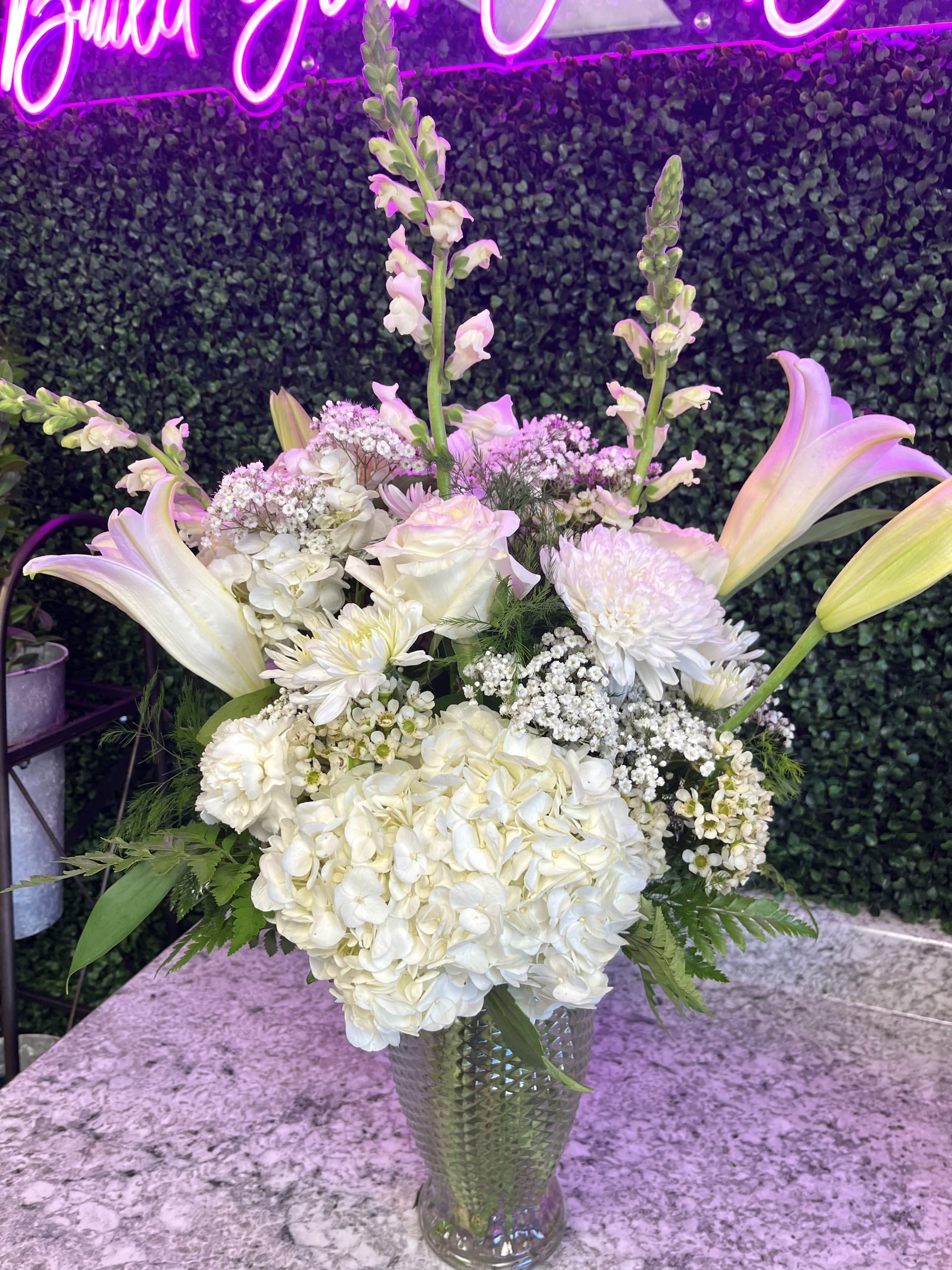 All-White Classics  - This beautiful arrangement is made up of hydrangeas, cremones, cushion poms, carnations, snapdragons, roses, and white lilies. This is a perfect arrangement to give for any occasion that is simply elegant!
