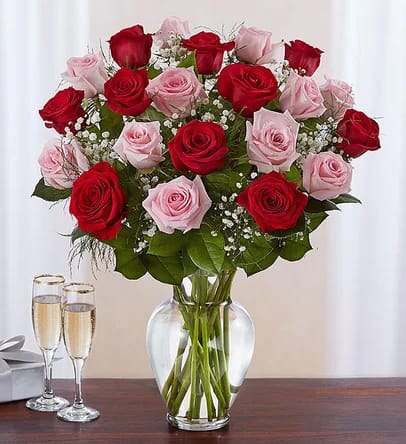 Ultimate Elegance™ Long Stem Pink &amp; Red Roses - Our radiant long stem roses are the ultimate romantic surprise. Two, three or four dozen blooms in charming pink &amp; classic red are artistically arranged by our expert florists inside an elegant glass vase and personally hand-delivered to help you express how you feel in a beautiful way.