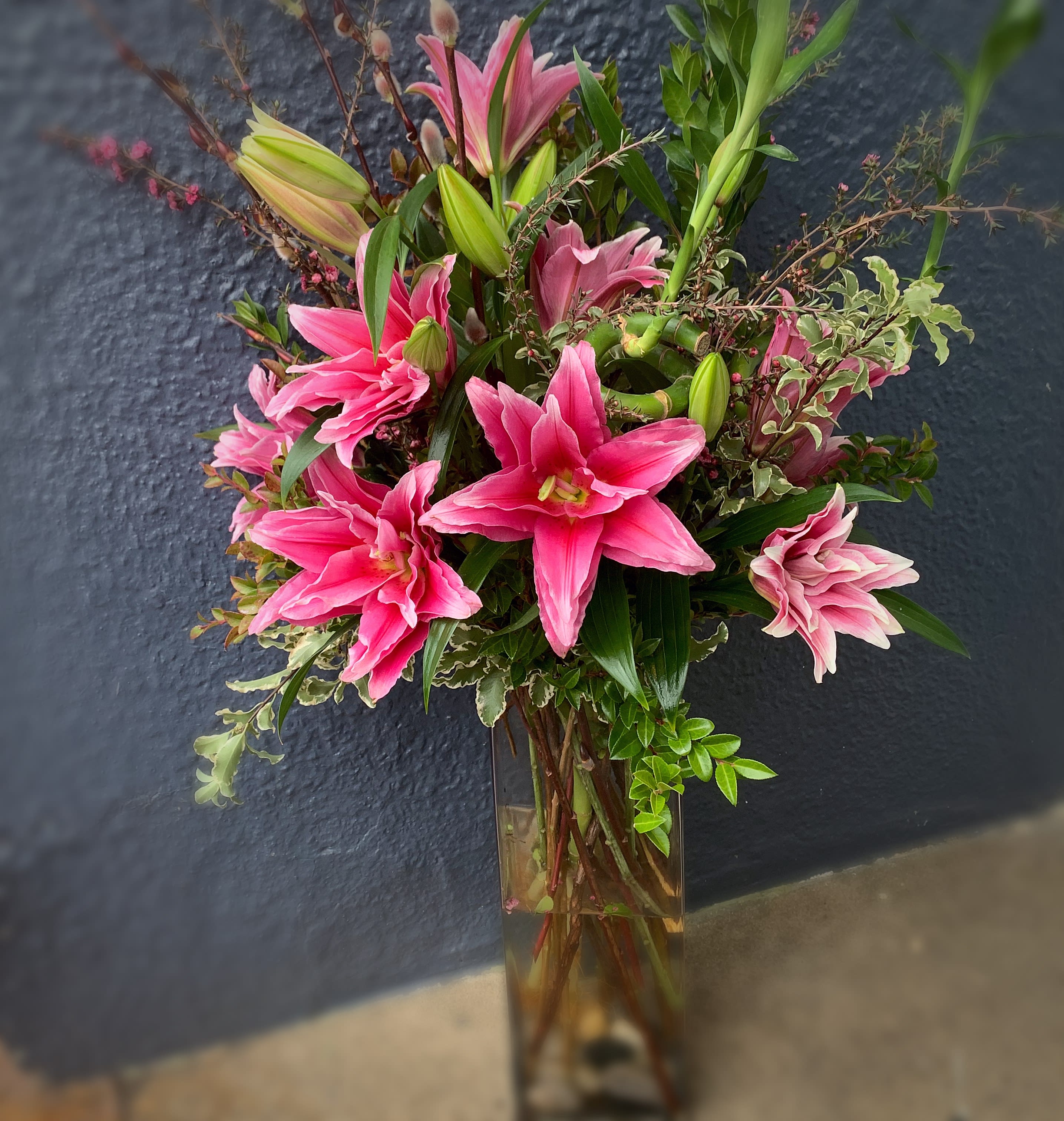 Style and Grace - Outstanding bright pink double lilies in a 16" rectangular glass container. 
