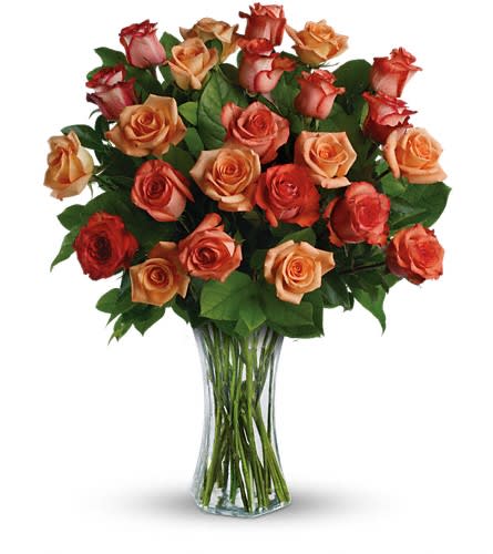 Sunrise Splendor - Send her a vase full of sunshine - glorious roses in brilliant shades of orange light orange and dark orange. Delivered in a sparkling flared vase this is a dazzling gift that will warm her heart for days - maybe weeks. This dazzling bouquet includes orange roses light orange roses and dark orange roses accented with salal. Delivered in a flared glass vase.Approximately 23" W x 28 1/2" H Orientation: All-Around As Shown : TRS08-1ADeluxe : TRS08-1B