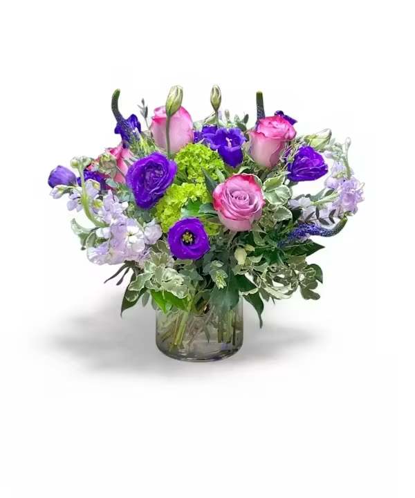  Melanie - Purple beauty: this arrangement stands out for its fragrant stock, soft lavender roses, and the finesse of lisianthus. A charming choice with a royal touch.  All Occasion Crystal Clear Glass Vessel  Place your Order Online Monday to Saturday before 1:00 p.m. (E.T.) for same-day delivery. “Orders received after hours will be delivered the next business day”. Check our coverage area. Occasionally, substitutions of flowers and/or containers happen due to weather, seasonality, and market conditions which may affect availability. If this is the case with the gift you’ve selected, we will ensure that the style, theme, and color scheme of your arrangement are preserved and will only substitute items of equal value or higher value.  CARE INSTRUCTIONS Keep the flower arrangement hydrated with natural water and change the water every two days. Do not spray any cleaning product on the flower arrangement. Do not place heavy objects directly on the flower arrangement. Keep flower arrangements out of direct sunlight and extreme heat.