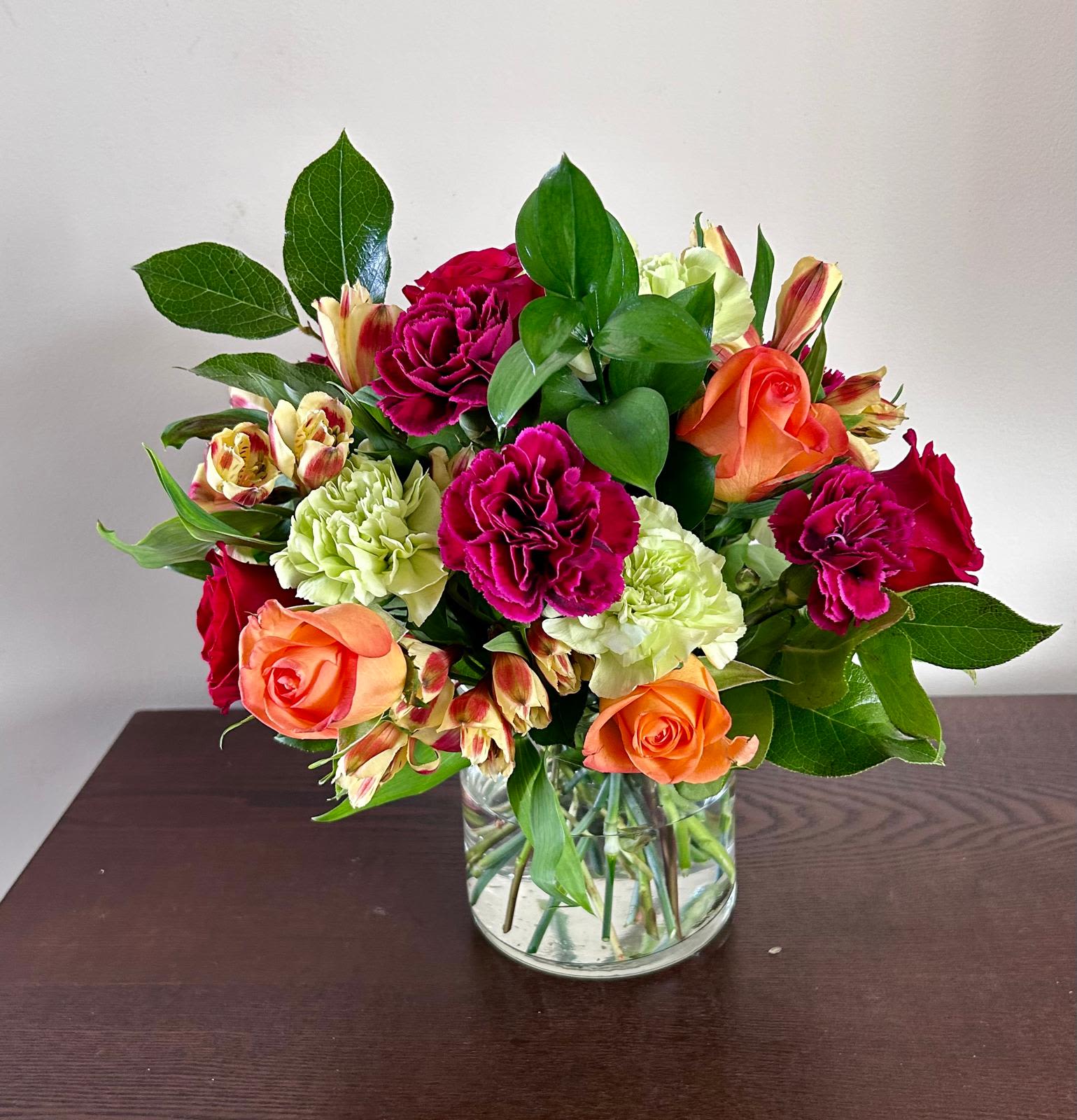 Billie  - Billie Bouquet is composed of a lively mix, fit to celebrate any and every moment. With a combination of vibrant flowers, this florist–designed arrangement brings a pop of color and a burst of excitement as soon as it arrives. Fresh flower arrangement along fine foliage. All Occasion Crystal Clear Glass Vessel  Place your Order Online Monday to Saturday before 1:00 p.m. (E.T.) for same-day delivery. “Orders received after hours will be delivered the next business day”. Check our coverage area.  Occasionally, flowers and/or container substitutions happen due to weather, seasonality, and market conditions, which may affect availability. If this is the case with the gift you’ve selected, we will ensure that your arrangement's style, theme, and color scheme are preserved and will only substitute items of equal value or higher value.  CARE INSTRUCTIONS Keep the flower arrangement hydrated with natural water and change the water every two days. Do not spray any cleaning product on the flower arrangement. Do not place heavy objects directly on the flower arrangement. Keep flower arrangements out of direct sunlight and extreme heat.