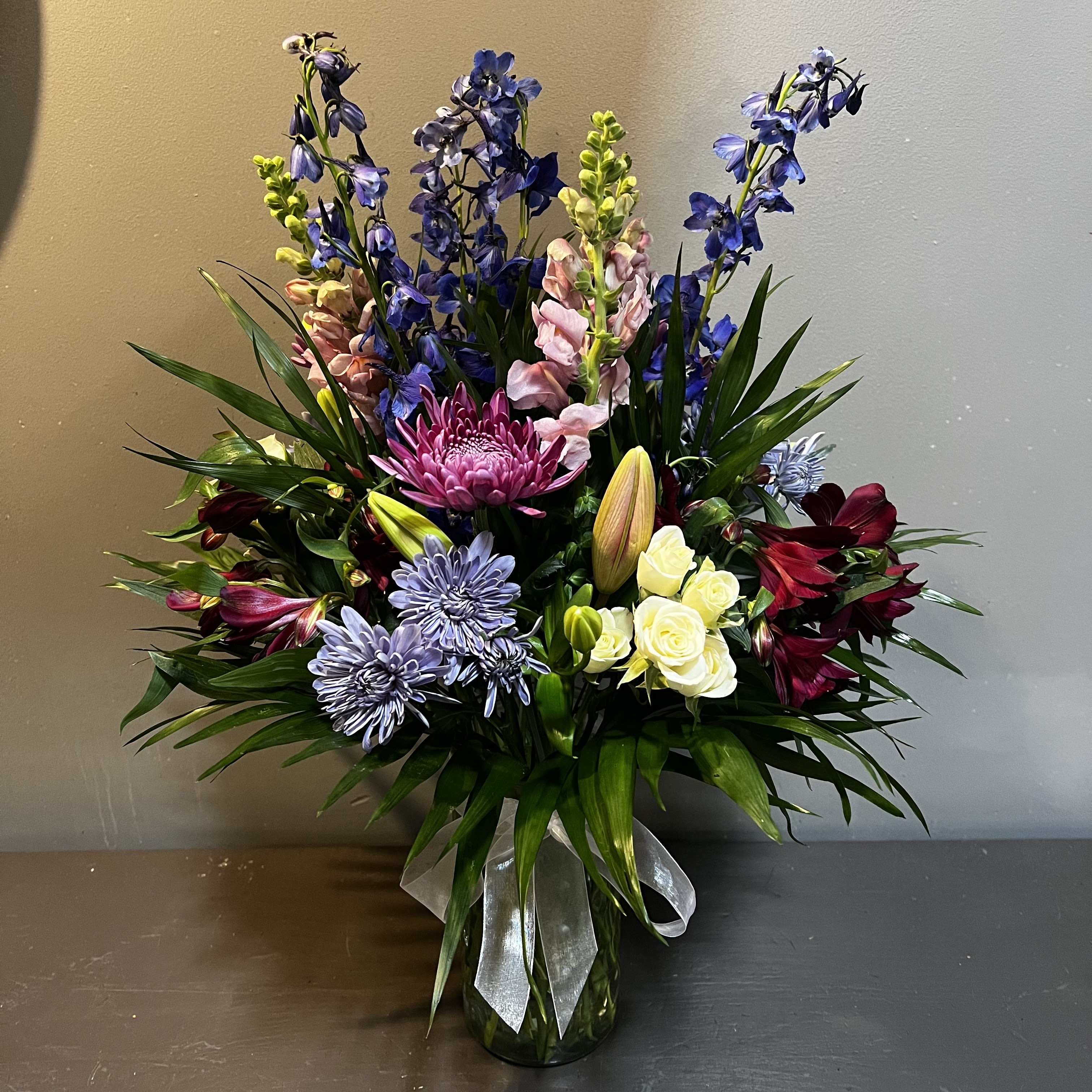 Jewel of my Eye - A luscious bouquet filled with jewel tones.  Measures approx. 26" tall x 19" wide and arrives in a glass vase.