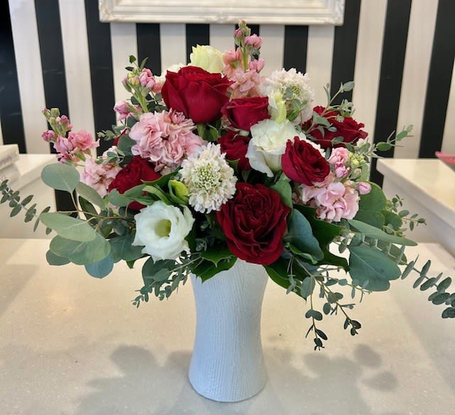 Valencia Valentine - A fresh assortment, of pinks, reds and whites clustered together in a white ceramic vase.