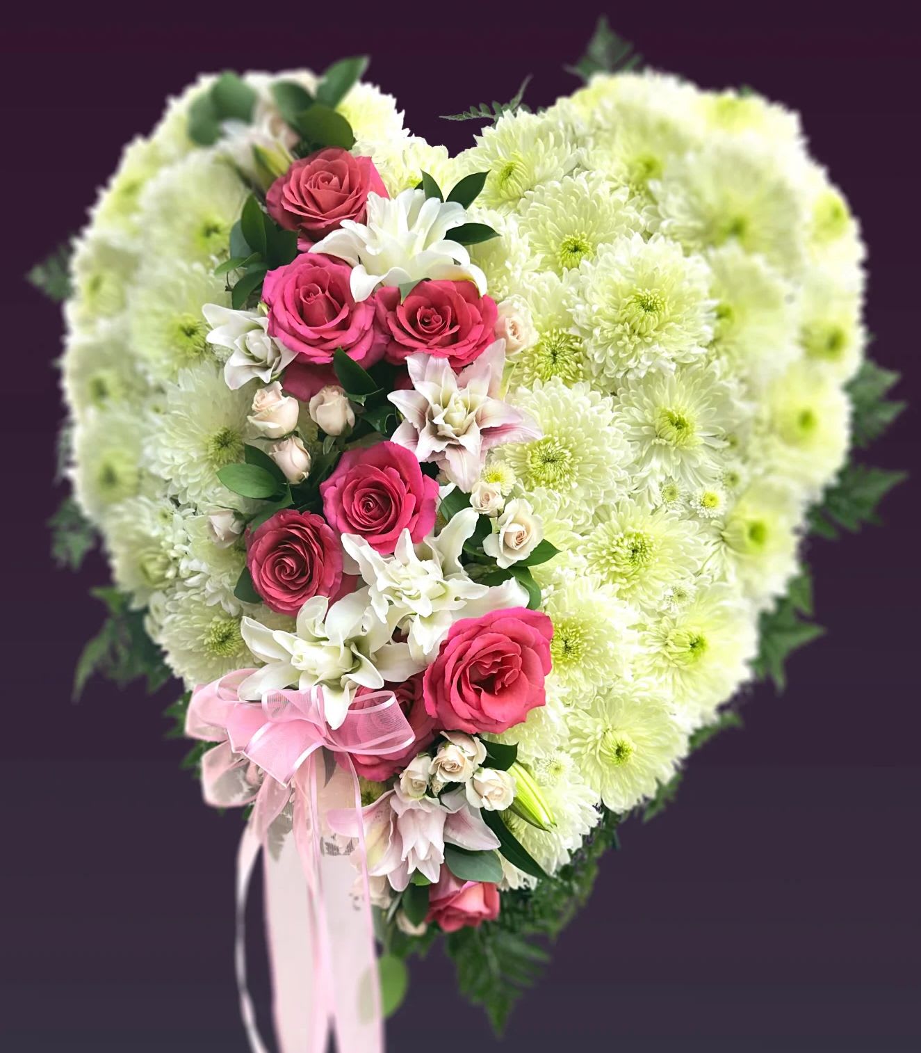 Forever Broken  - Saying farewell to your beloved one is not easy. This heart simply states how much love and memories you will hold in your heart. Solid 20” heart filled with mums, lilies, and roses. 