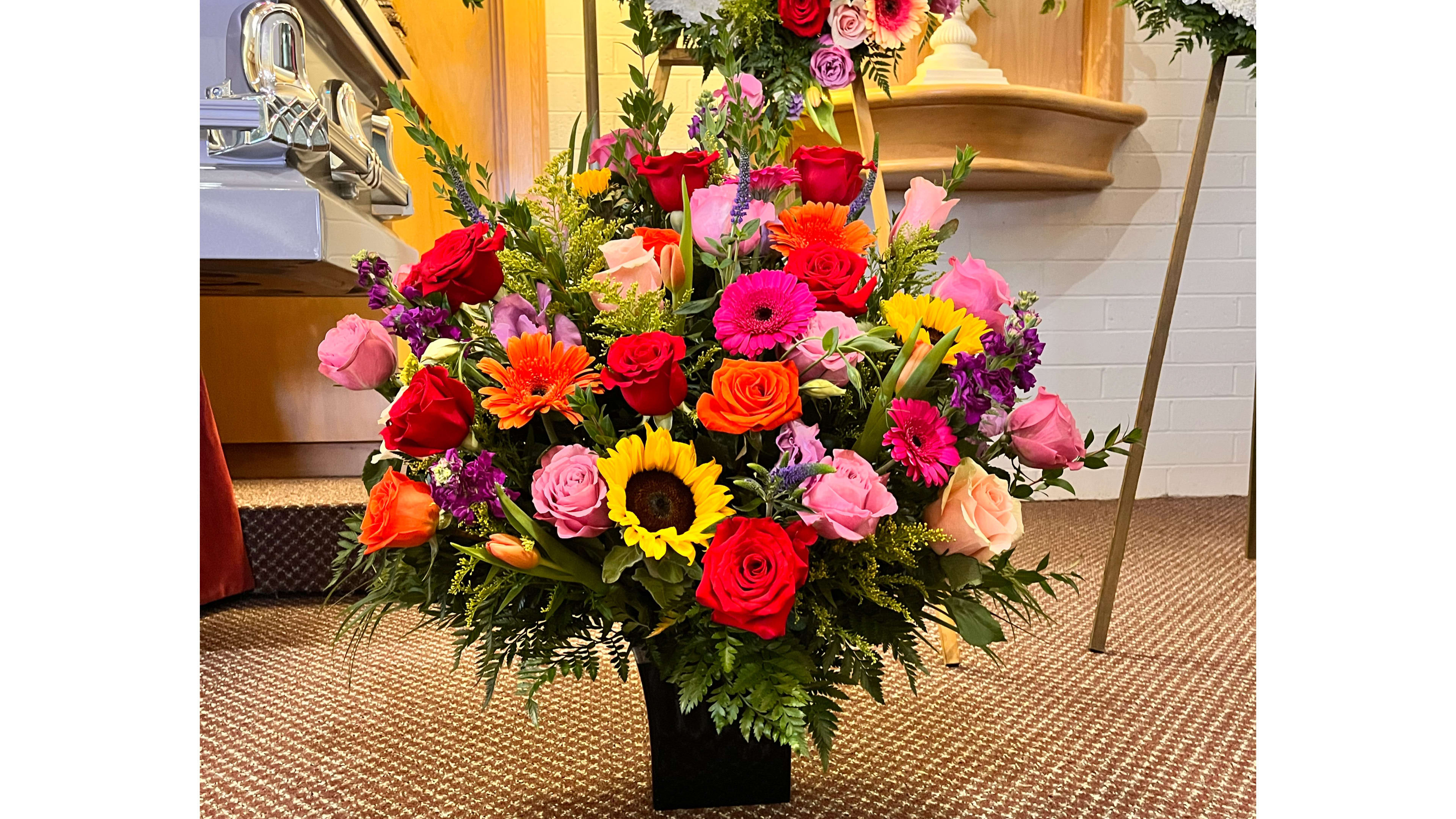 Warm and bright side basket  - A beautiful collection of warm and bright flowers that create a beautiful sympathy arrangement. 