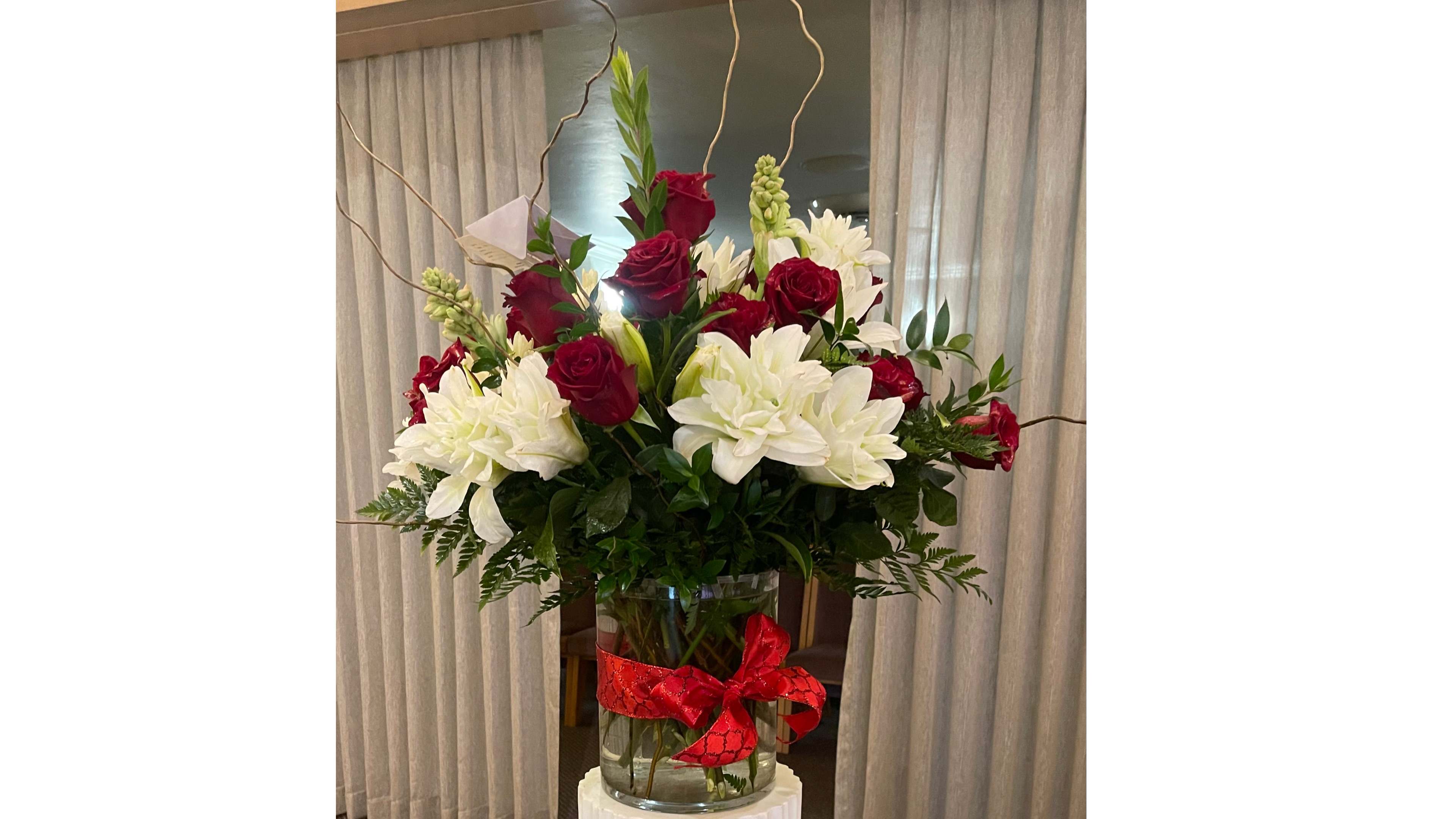 Beauty Red Roses - A vase arrangement with Red roses, white double lilies, tuberose, and curly willow.   