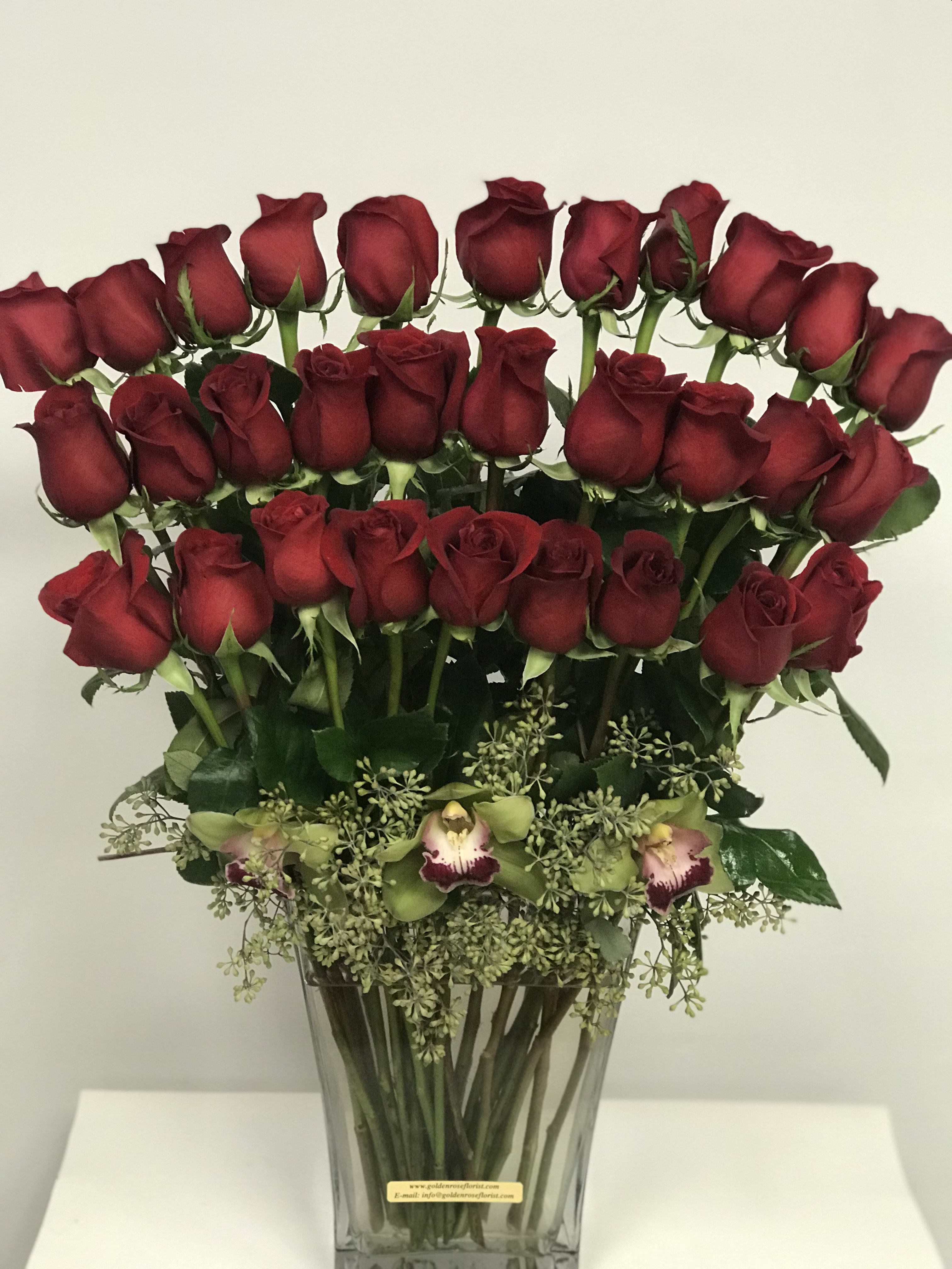 Cod1344 - 36 Ecuadorian Red Roses + Cymbidium Orchid Substitution &amp; Design Policy  AS SIMILAR AS POSSIBLE  Each floral arrangement is custom-designed and handcrafted using the freshest flowers, containers, decorative accents, and materials available at the time of creation. Due to seasonal availability, immediate inventory conditions, market limitations, or unforeseen circumstances, substitutions of flowers, containers, or decorative elements may be necessary.  When substitutions occur, they will always be made with items of equal or greater value, while preserving the overall style, color palette, proportions, and design integrity of the original arrangement. The final product will be delivered as similar as possible to the design shown.  By placing an order, you acknowledge that all floral designs are unique and that natural variations are part of the artistic and handcrafted process. Our commitment is to deliver the most beautiful and refined version of each arrangement, consistent with our quality standards.