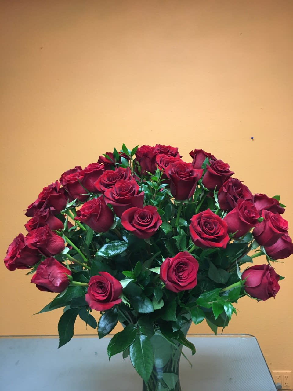 COD1503 - RED ROSES   Substitution &amp; Design Policy  AS SIMILAR AS POSSIBLE  Each floral arrangement is custom-designed and handcrafted using the freshest flowers, containers, decorative accents, and materials available at the time of creation. Due to seasonal availability, immediate inventory conditions, market limitations, or unforeseen circumstances, substitutions of flowers, containers, or decorative elements may be necessary.  When substitutions occur, they will always be made with items of equal or greater value, while preserving the overall style, color palette, proportions, and design integrity of the original arrangement. The final product will be delivered as similar as possible to the design shown.  By placing an order, you acknowledge that all floral designs are unique and that natural variations are part of the artistic and handcrafted process. Our commitment is to deliver the most beautiful and refined version of each arrangement, consistent with our quality standards.