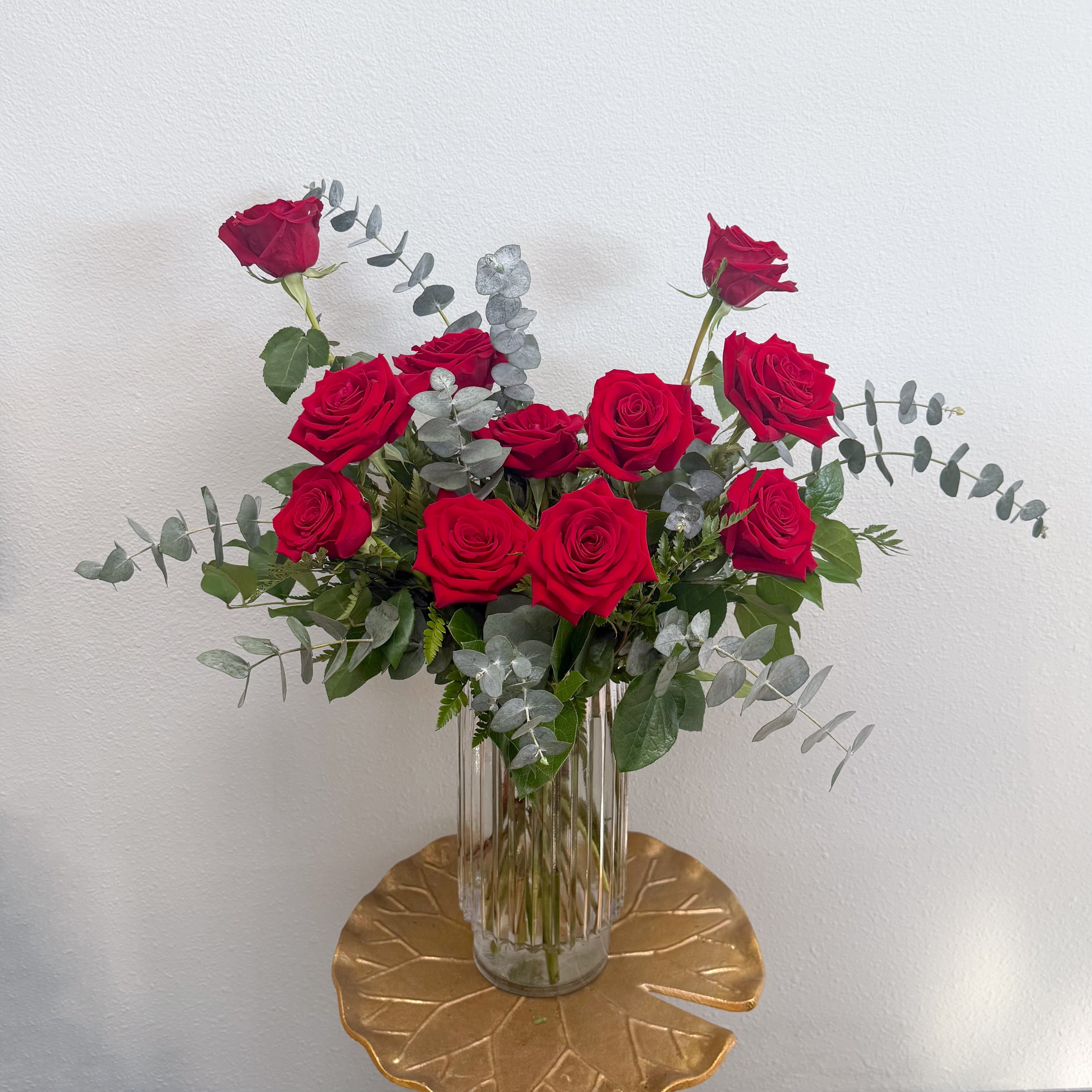 The Elevated Dozen - One dozen premium Ecuadorian roses in a classy ribbed vase with a mix of greenery. Styled to bring the classic dozen into the modern age.   