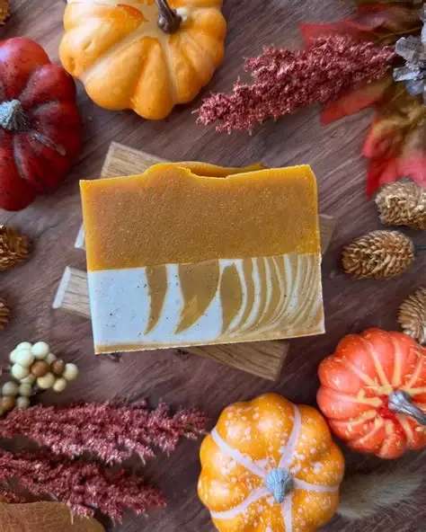 Orange Maple Soap  - Ashley Marie's Orange Maple Soap is a seasonal favorite that captures the cozy essence of autumn with a citrus twist. It features a blend of sweet orange, balsam peru, and vanilla oleoresin, creating a scent that is both comforting and uplifting. The soap is crafted with organic oils, cacao, and spice, ensuring soft, nourished skin. It is colored naturally with annatto, cacao, and kaolin clay, adding to its beauty and indulgence. The ingredients include saponified 100% Extra Virgin Olive Oil, rice bran oil, coconut oil, castor oil, avocado oil, shea butter, kaolin clay, infused annatto, cacao, allspice, and an essential oil blend of organic sweet orange, peru balsam, vanilla oleoresin, and organic cedarwood. This soap is perfect for those looking to indulge in a sweet and warm scent during the autumn season.