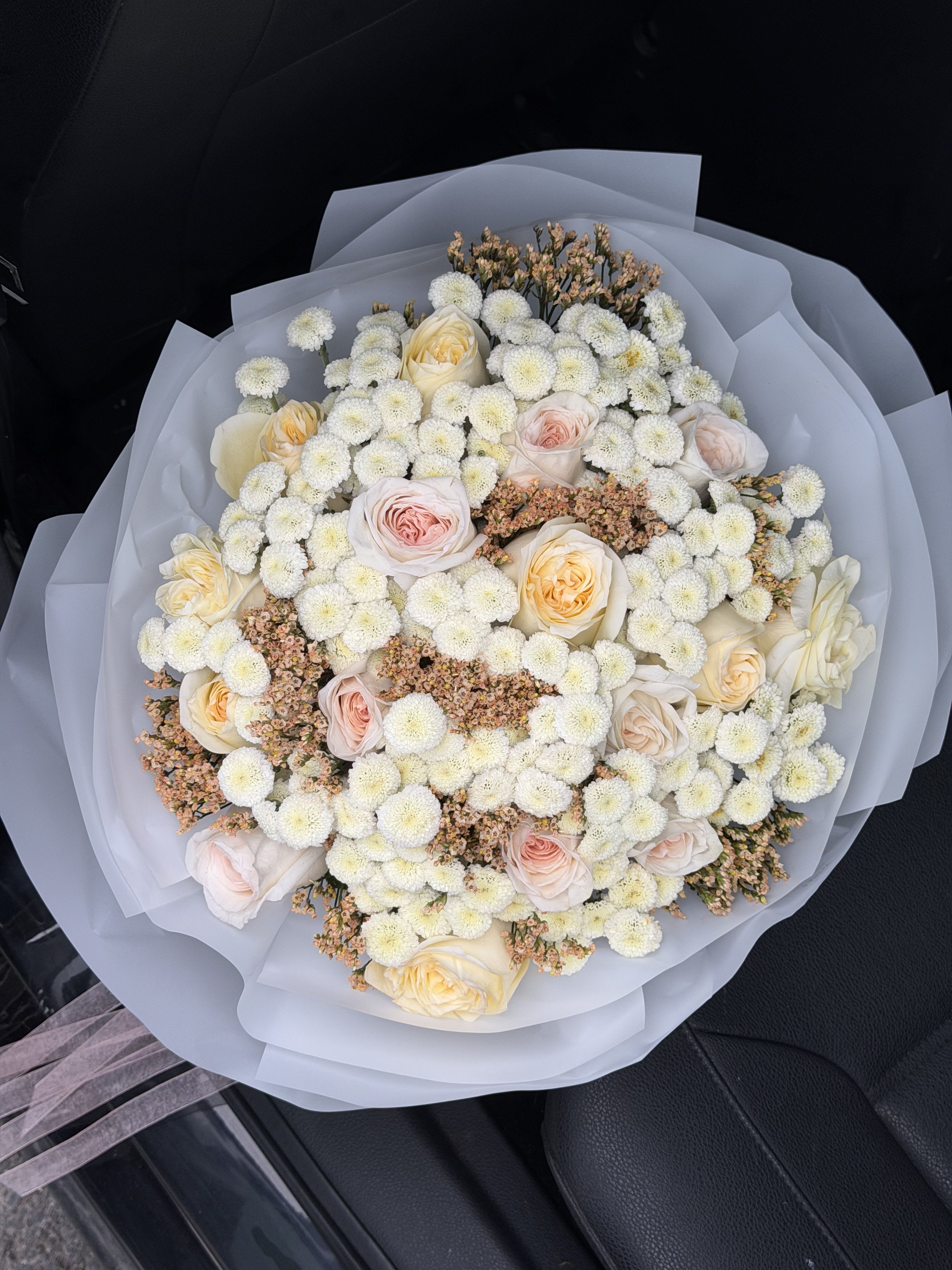 Delicate Bouquet of Roses, Chrysanthemums and Limonium - This delicate bouquet is a harmonious blend of elegance, softness, and timeless beauty. Carefully composed with fresh roses, graceful chrysanthemums, and airy limonium, it creates a light and romantic arrangement that speaks of tenderness and sincere emotions.  The roses add a classic touch of love and refinement, symbolizing deep feelings and admiration. Chrysanthemums bring a sense of calm, warmth, and longevity, making the bouquet not only beautiful but meaningful. Limonium completes the composition with its cloud-like texture, adding volume and an ethereal charm that enhances the bouquet’s natural softness.  This bouquet is perfect for a wide range of occasions — birthdays, anniversaries, romantic dates, expressions of gratitude, or simply to bring joy and warmth to someone’s day. Its gentle color palette makes it a versatile choice that suits both intimate moments and elegant celebrations.  Each bouquet is handcrafted by our florists with attention to detail, using only fresh, high-quality flowers to ensure long-lasting beauty and freshness. A thoughtful and graceful gift that will leave a lasting impression and convey your feelings in the most delicate way. 