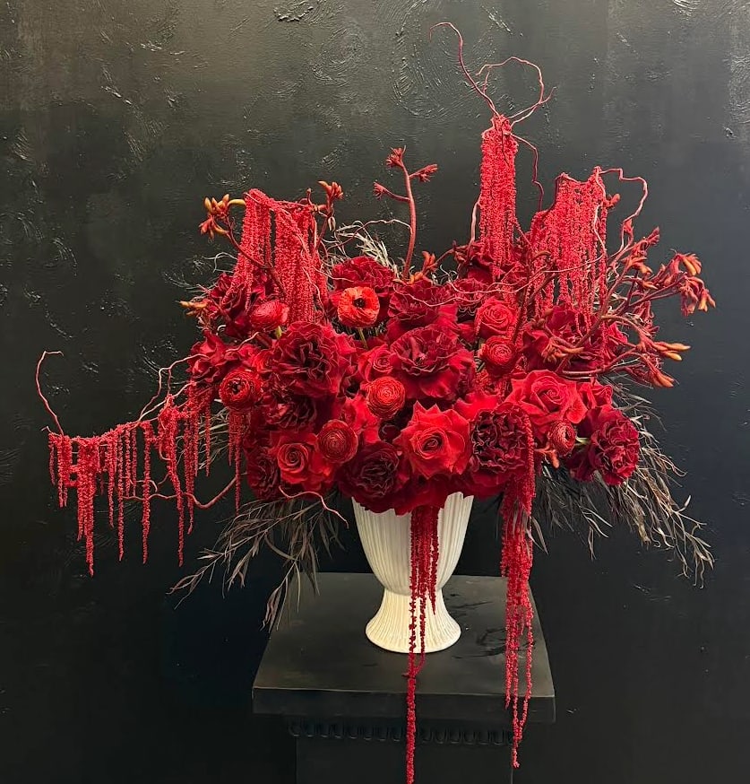 Scarlet Grace - A beautiful mix of rich red flowers arranged with timeless elegance, Scarlet Grace is a classic expression of love and sophistication. Featuring lush red blooms in varying textures and tones, this all-red arrangement creates depth, warmth, and undeniable beauty. Designed to feel traditional yet refined, it’s perfect for meaningful occasions, formal settings, and moments that call for enduring romance.