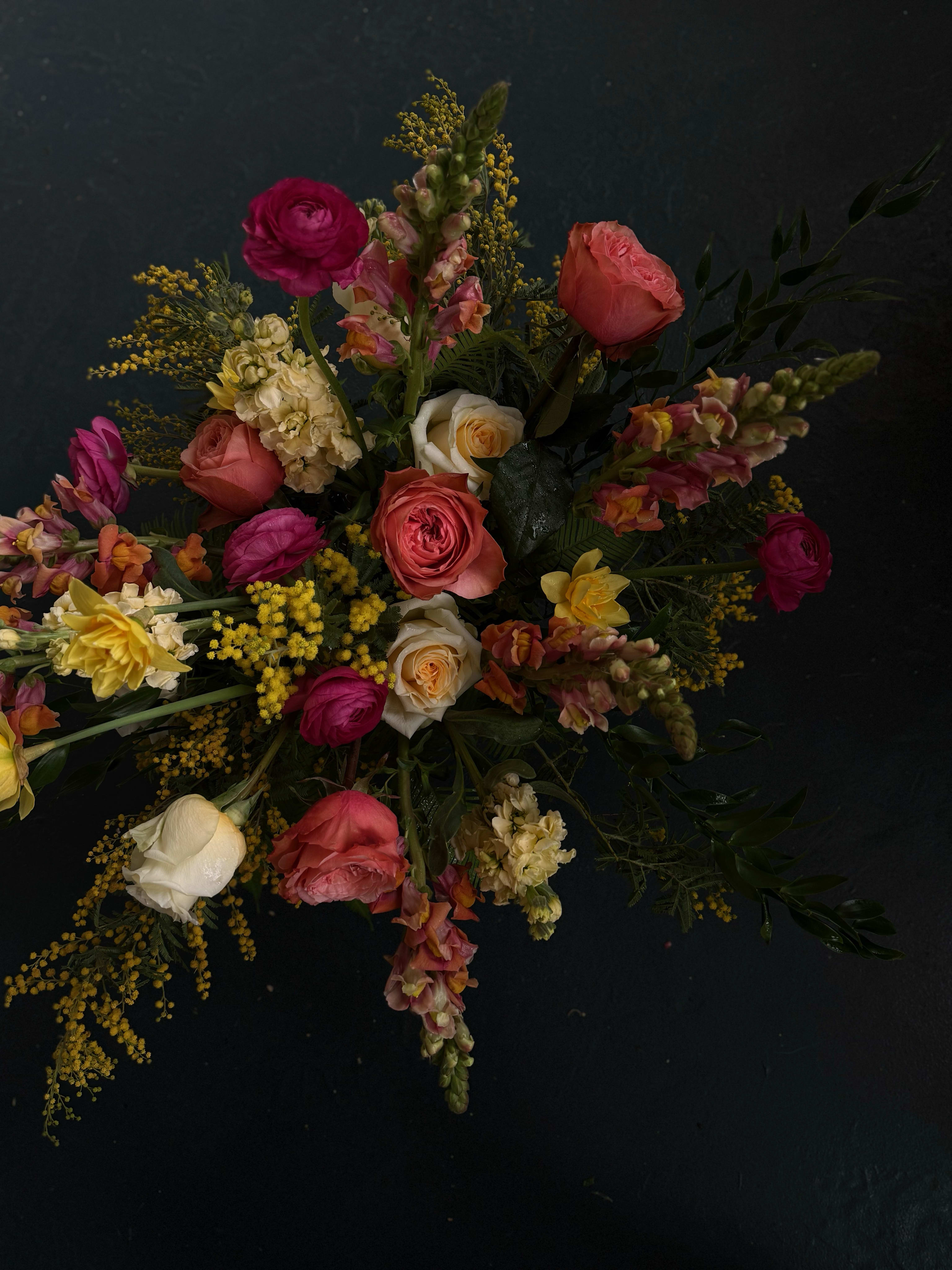 VIBRANT. Designer's Choice Epic Vase Arrangement - A show-stopping floral masterpiece overflowing with bold color, dynamic texture, and artistic flair. Designed in a statement vase, this arrangement is lush, luxurious, and full of personality.