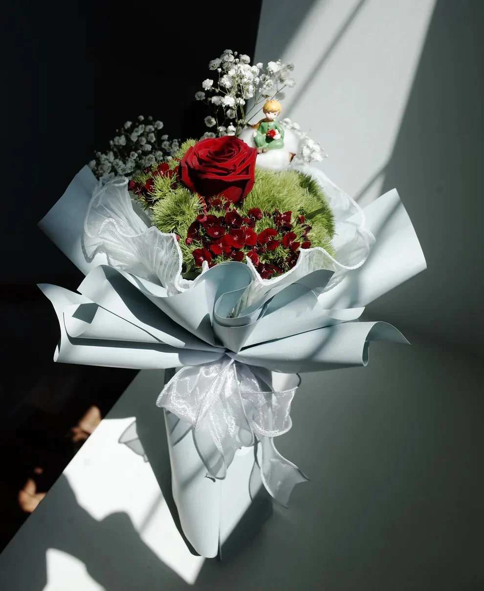 The Little Prince’s Rose Bouquet -  Inspired by the beloved tale of The Little Prince, this bouquet captures the magic of innocence, love, and devotion. Featuring delicate roses arranged with thoughtful artistry, it symbolizes the cherished bond between the Prince and his rose—a story of care, tenderness, and timeless beauty.  Perfect for romantics, dreamers, or anyone who treasures meaningful blooms, this bouquet is more than flowers